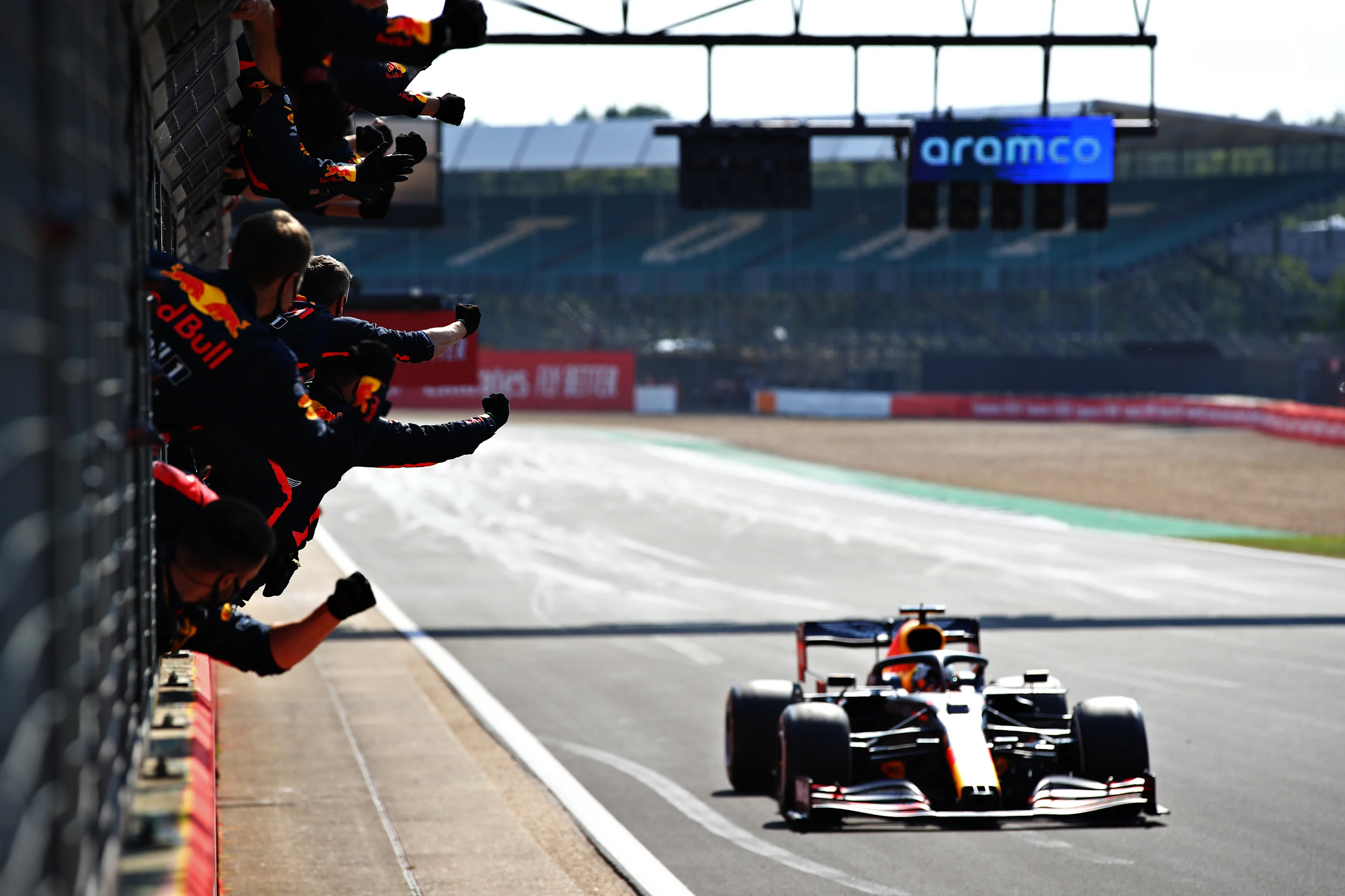 NORTHAMPTON, ENGLAND - AUGUST 09: The Red Bull Racing team celebrate on the pitwall as race winner