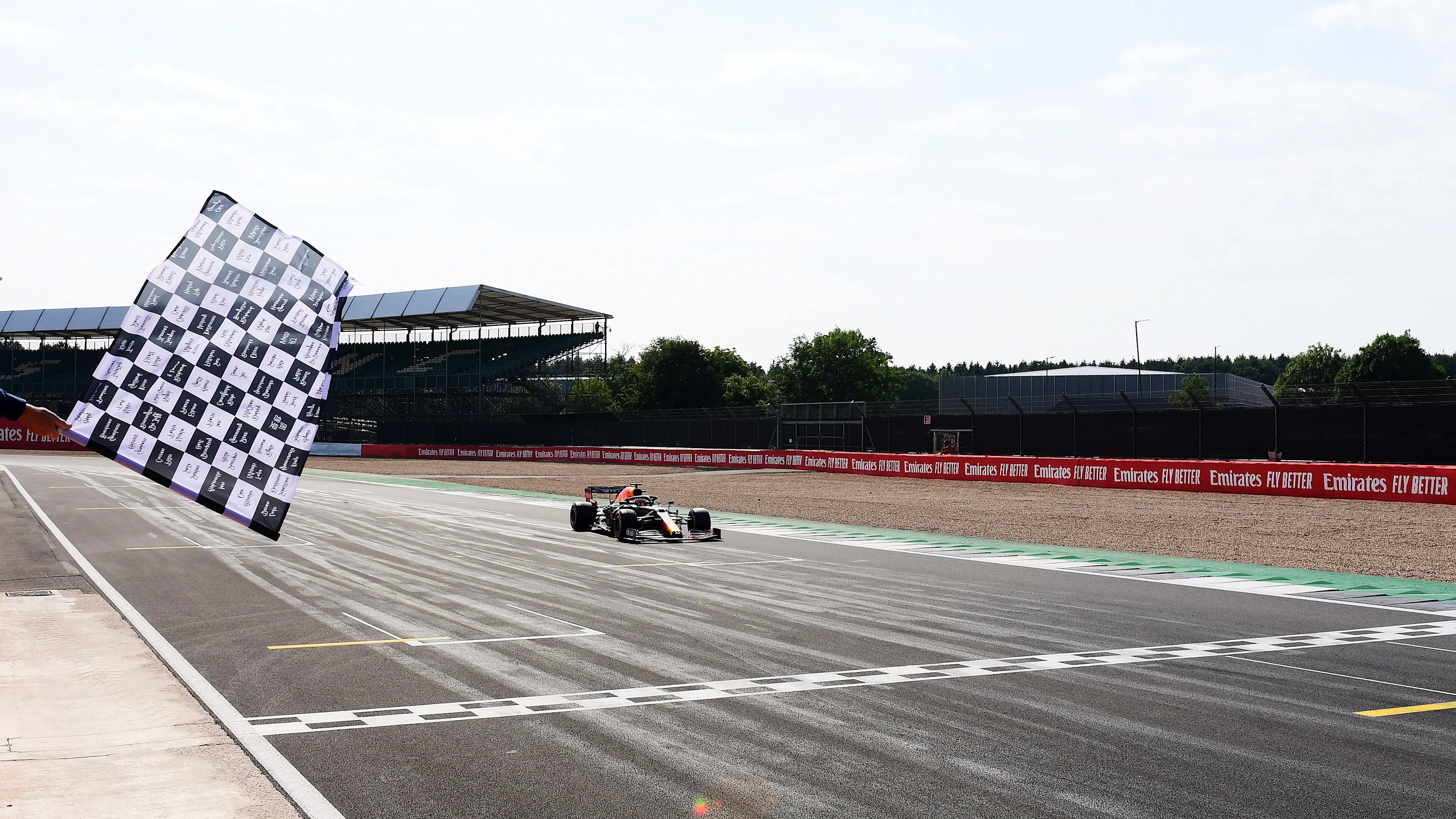 NORTHAMPTON, ENGLAND - AUGUST 09: race winner Max Verstappen of Netherlands and Red Bull Racing crosses the finish line during the F1 70th Anniversary Grand Prix at Silverstone on August 09, 2020 in Northampton, England. (Photo by Mario Renzi - Formula 1/Formula 1 via Getty Images)
