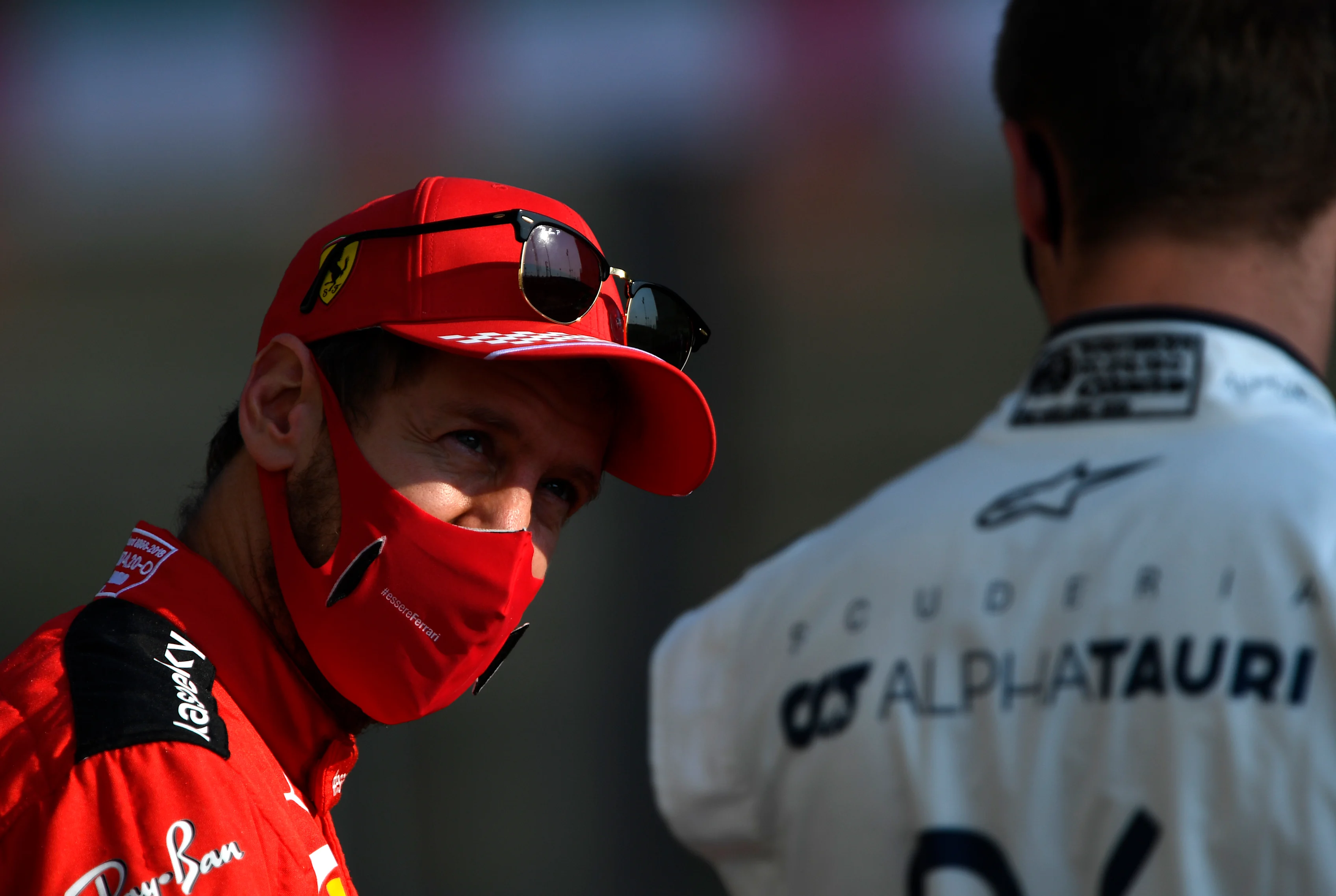 ABU DHABI, UNITED ARAB EMIRATES - DECEMBER 13: Sebastian Vettel of Germany and Ferrari talks with