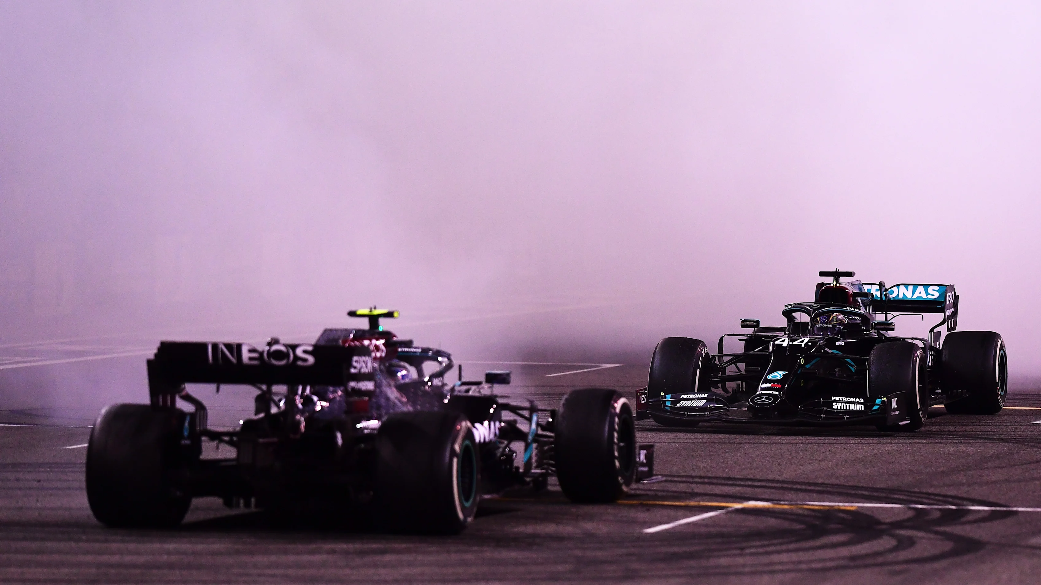 ABU DHABI, UNITED ARAB EMIRATES - DECEMBER 13: Second placed Valtteri Bottas of Finland and Mercedes GP and third placed Lewis Hamilton of Great Britain and Mercedes GP perform donuts following the F1 Grand Prix of Abu Dhabi at Yas Marina Circuit on December 13, 2020 in Abu Dhabi, United Arab Emirates. (Photo by Mario Renzi - Formula 1/Formula 1 via Getty Images)