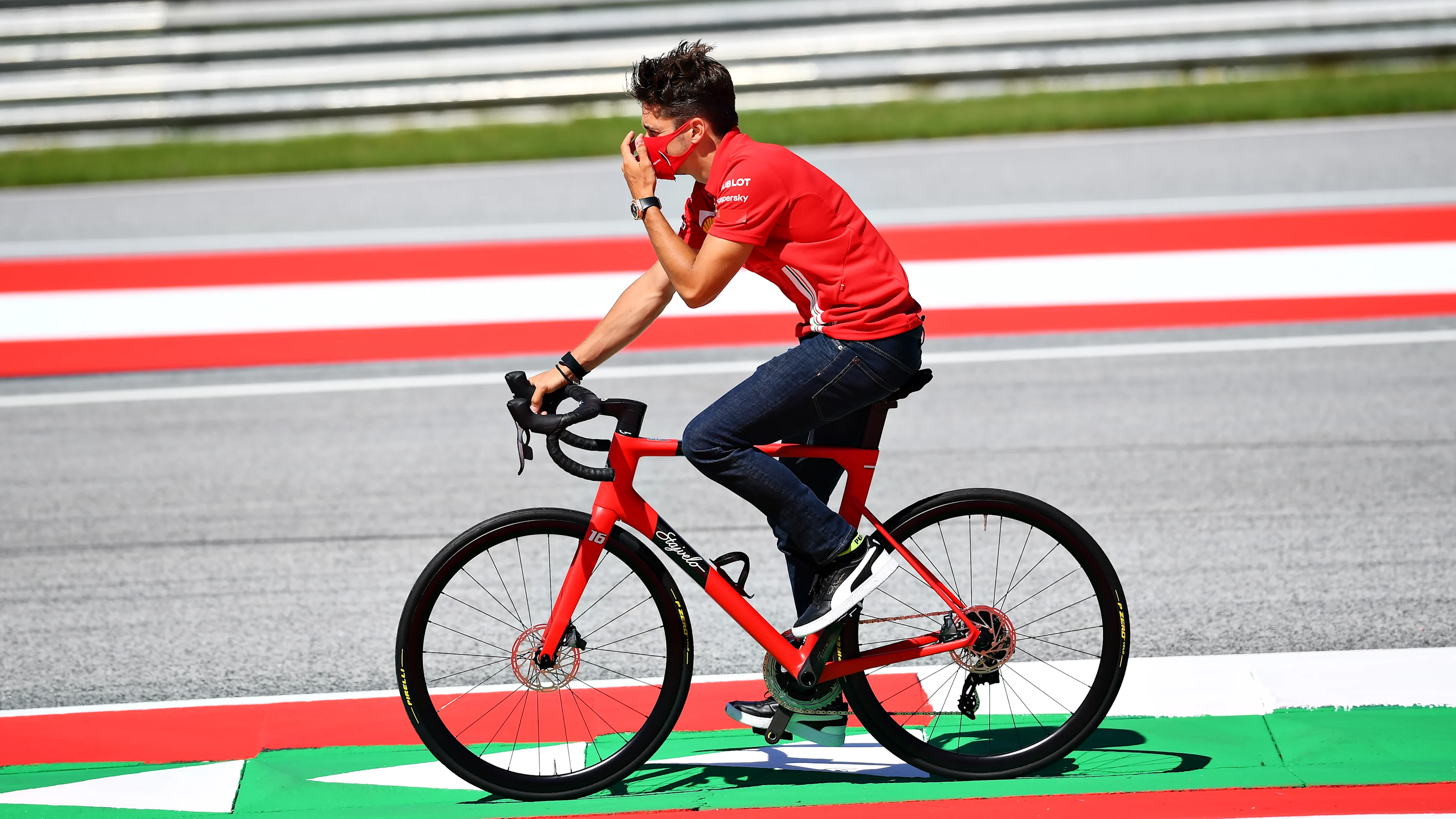 SPIELBERG, AUSTRIA - JULY 02: Charles Leclerc of Monaco and Ferrari cycles the track with his team