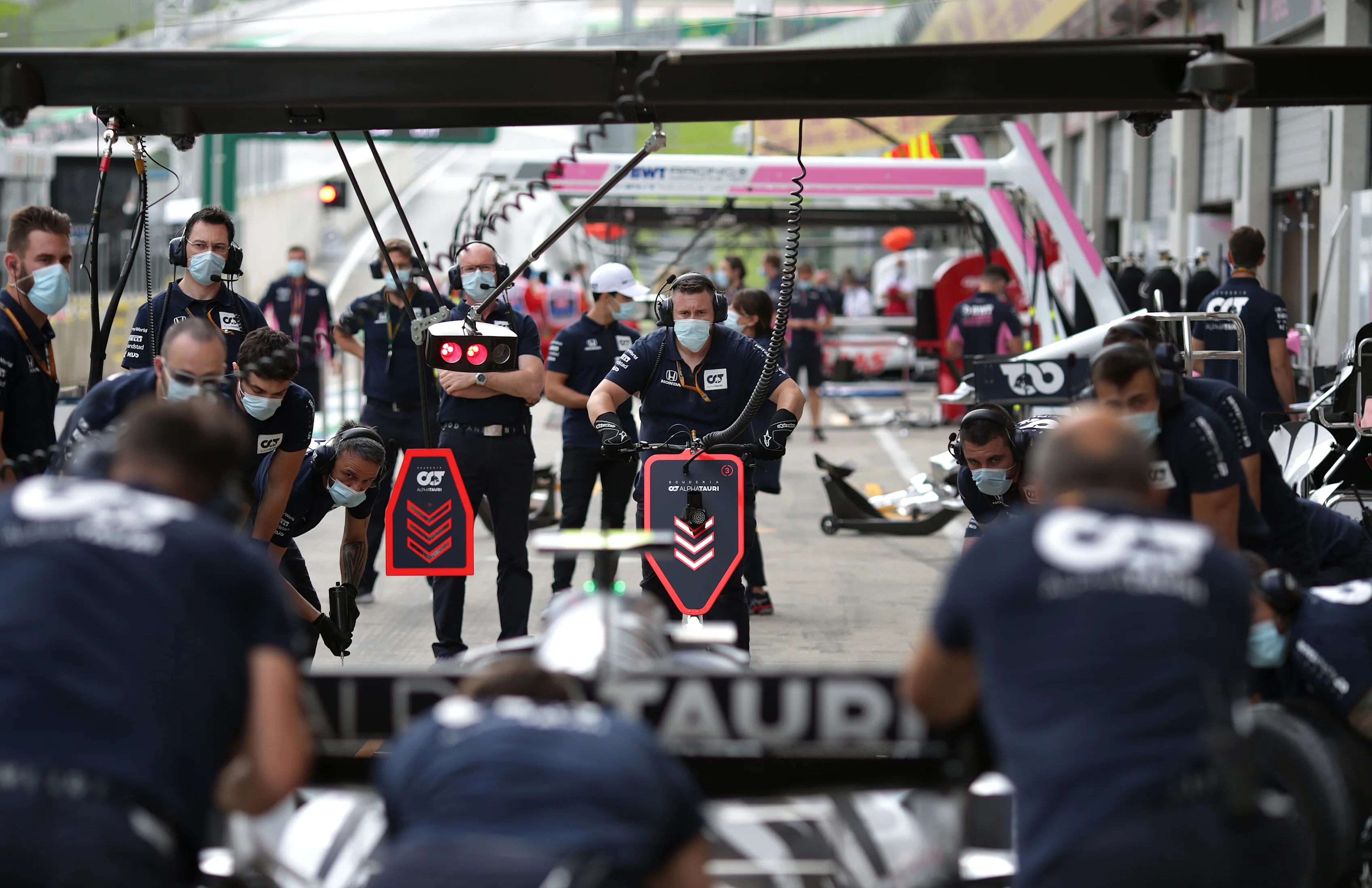 SPIELBERG, AUSTRIA - JULY 02: Scuderia AlphaTauri team members practice pit stops during previews
