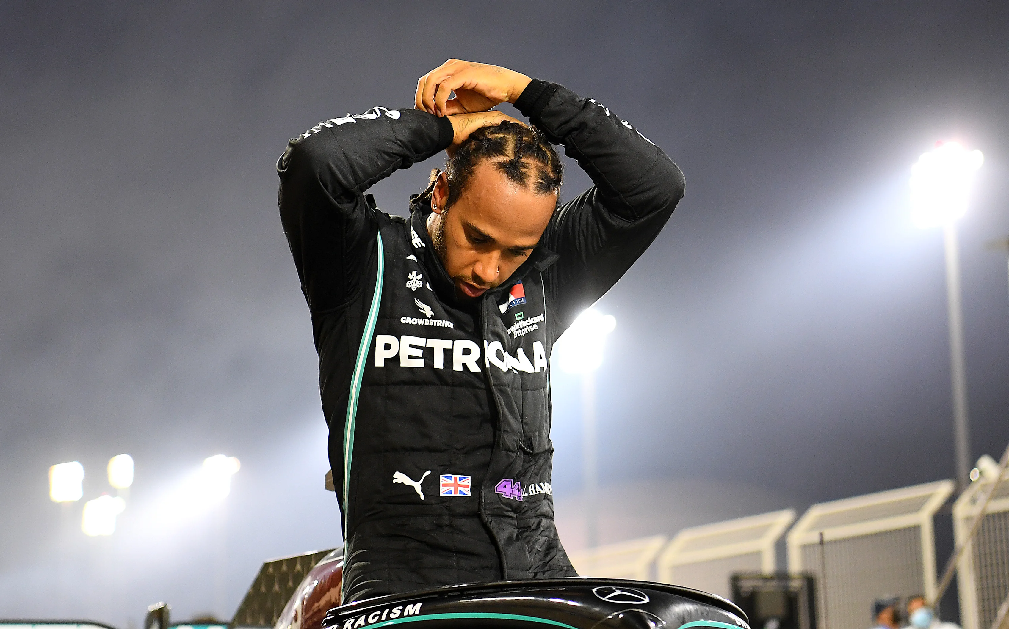 BAHRAIN, BAHRAIN - NOVEMBER 29: Race winner Lewis Hamilton of Great Britain and Mercedes GP climbs