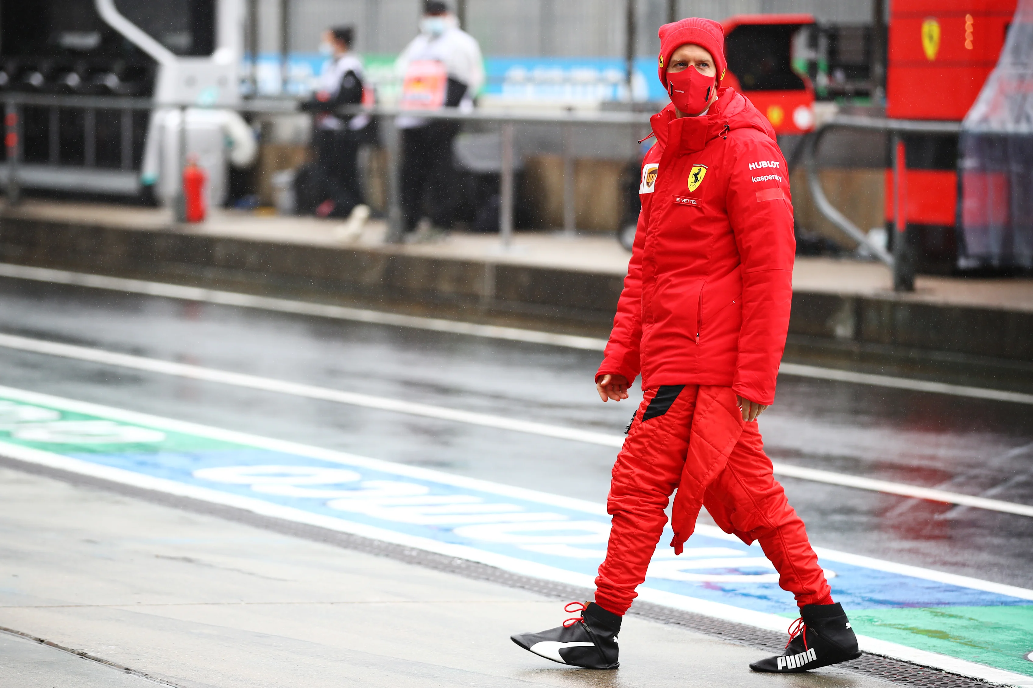 NUERBURG, GERMANY - OCTOBER 09: Sebastian Vettel of Germany and Ferrari walks in the Pitlane during