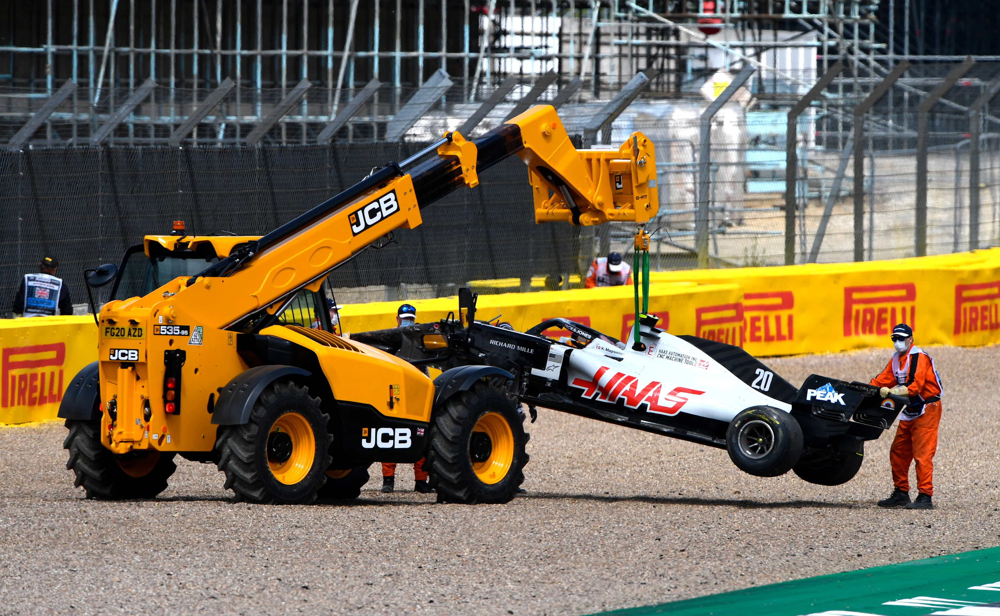 NORTHAMPTON, ENGLAND - AUGUST 02: The car of Kevin Magnussen of Denmark and Haas F1 is taken away