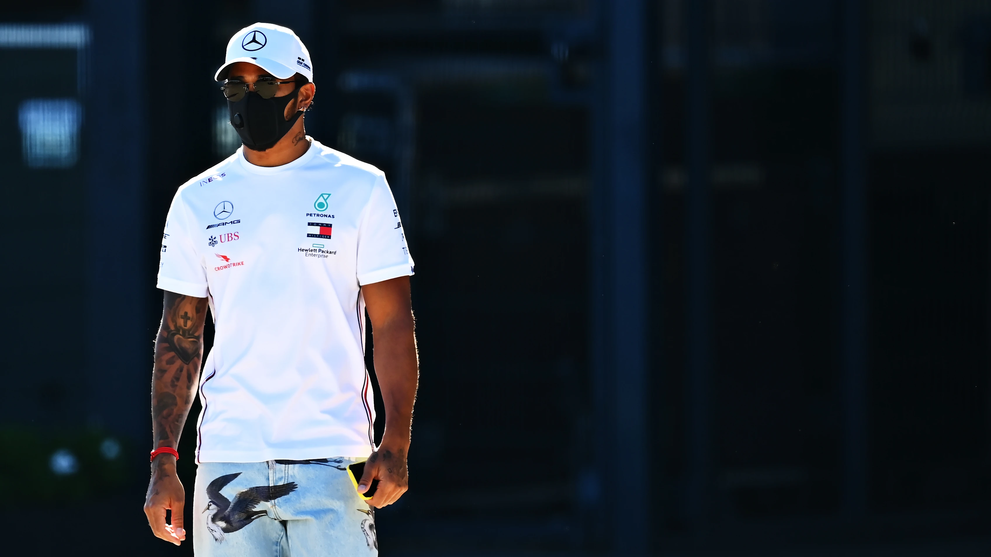 NORTHAMPTON, ENGLAND - JULY 30: Lewis Hamilton of Great Britain and Mercedes GP walks in the