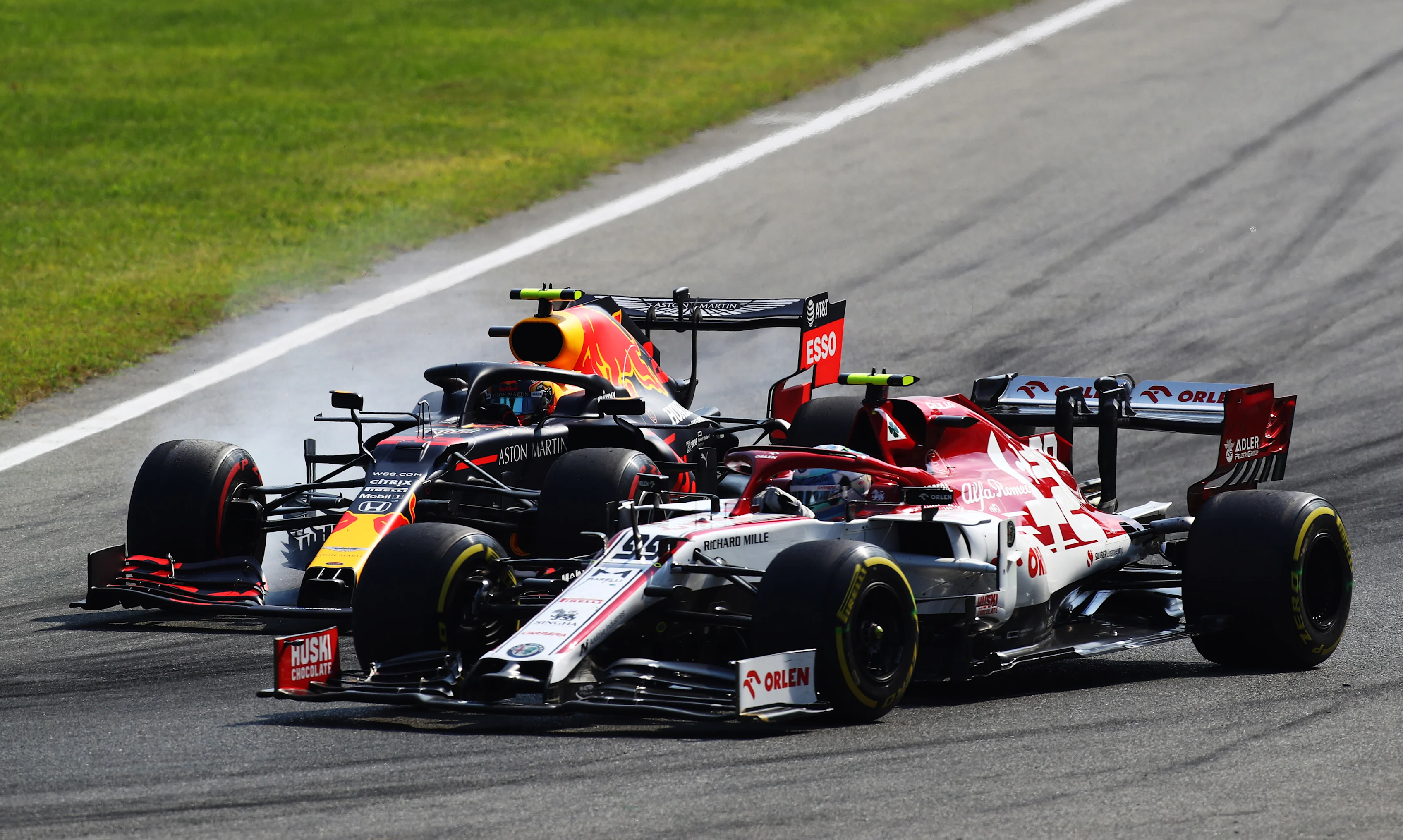 MONZA, ITALY - SEPTEMBER 06: Alexander Albon of Thailand driving the (23) Aston Martin Red Bull Racing RB16 and Antonio Giovinazzi of Italy driving the (99) Alfa Romeo Racing C39 Ferrari battle for position during the F1 Grand Prix of Italy at Autodromo di Monza on September 06, 2020 in Monza, Italy. (Photo by Mark Thompson/Getty Images)