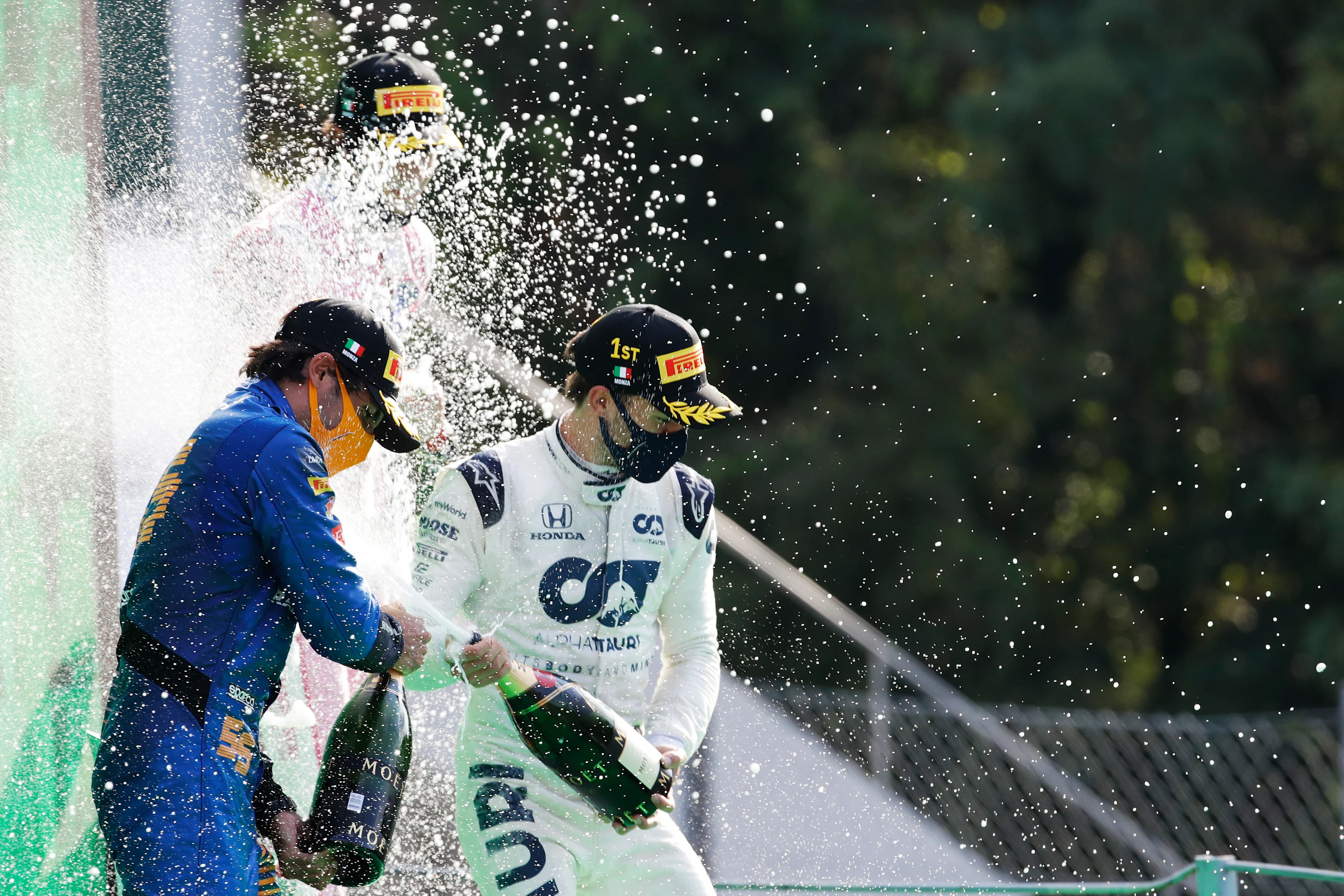MONZA, ITALY - SEPTEMBER 06: Race winner Pierre Gasly of France and Scuderia AlphaTauri and second placed Carlos Sainz of Spain and McLaren F1 celebrate on the podium during the F1 Grand Prix of Italy at Autodromo di Monza on September 06, 2020 in Monza, Italy. (Photo by Luca Bruno - Pool/Getty Images)