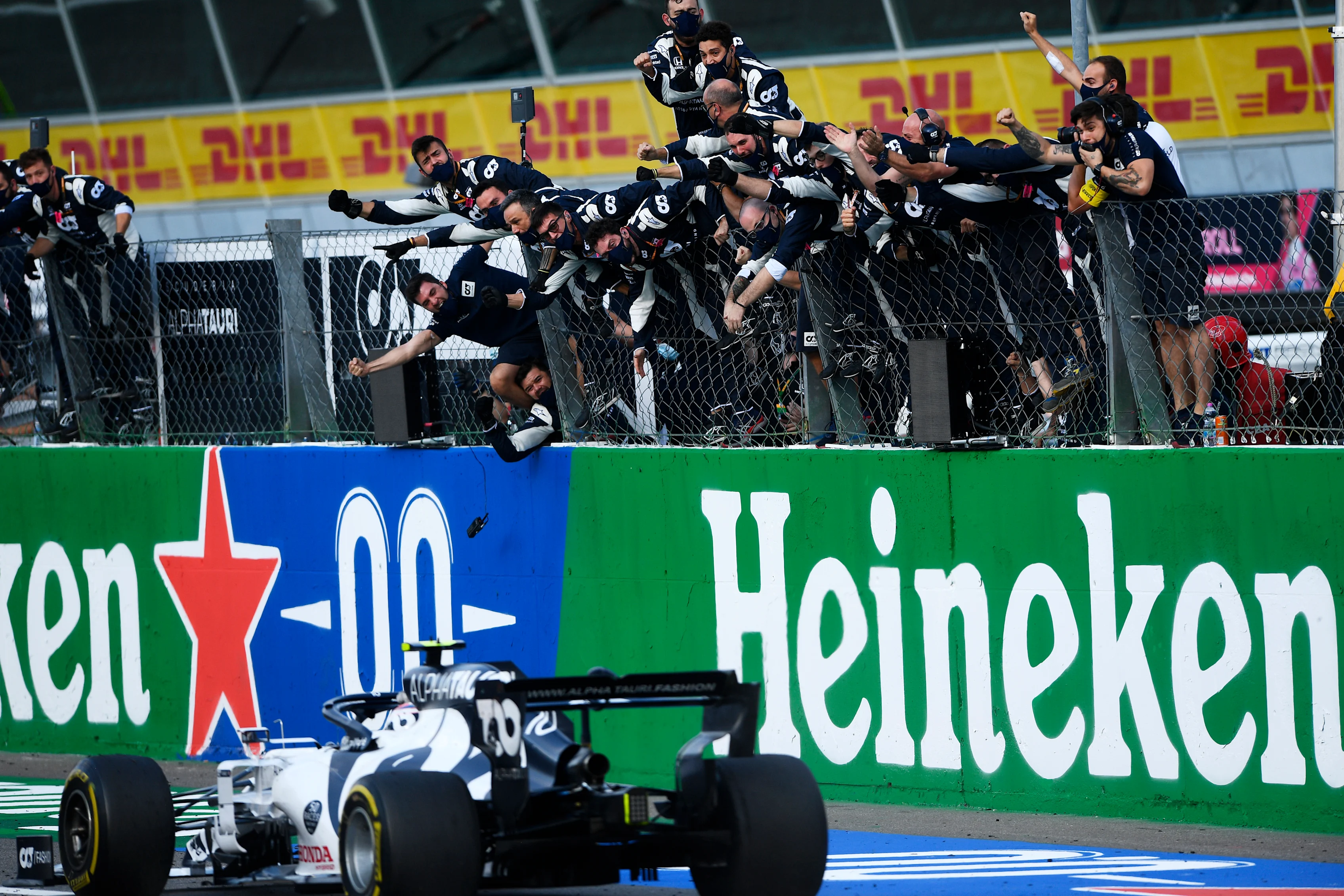 Scuderia AlphaTauri team members celebrate as Race winner Pierre Gasly crosses the finishing line during the F1 Grand Prix of Italy at Autodromo di Monza on September 06, 2020 in Monza, Italy. (Photo by Rudy Carezzevoli/Getty Images)