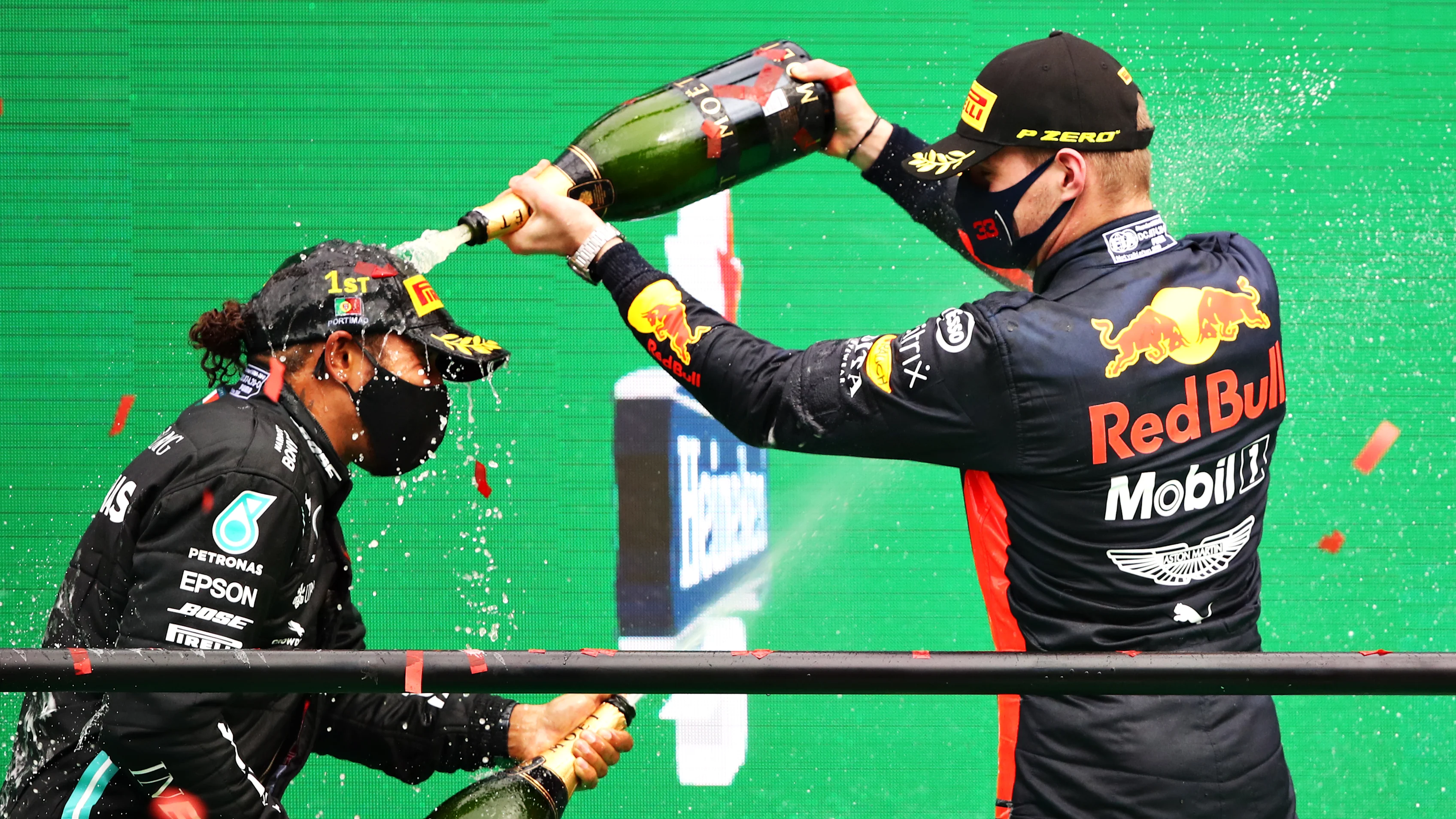 PORTIMAO, PORTUGAL - OCTOBER 25: Race winner Lewis Hamilton of Great Britain and Mercedes GP celebrates his record breaking 92nd race win on the podium with third placed Max Verstappen of Netherlands and Red Bull Racing during the F1 Grand Prix of Portugal at Autodromo Internacional do Algarve on October 25, 2020 in Portimao, Portugal. (Photo by Bryn Lennon - Formula 1/Formula 1 via Getty Images)