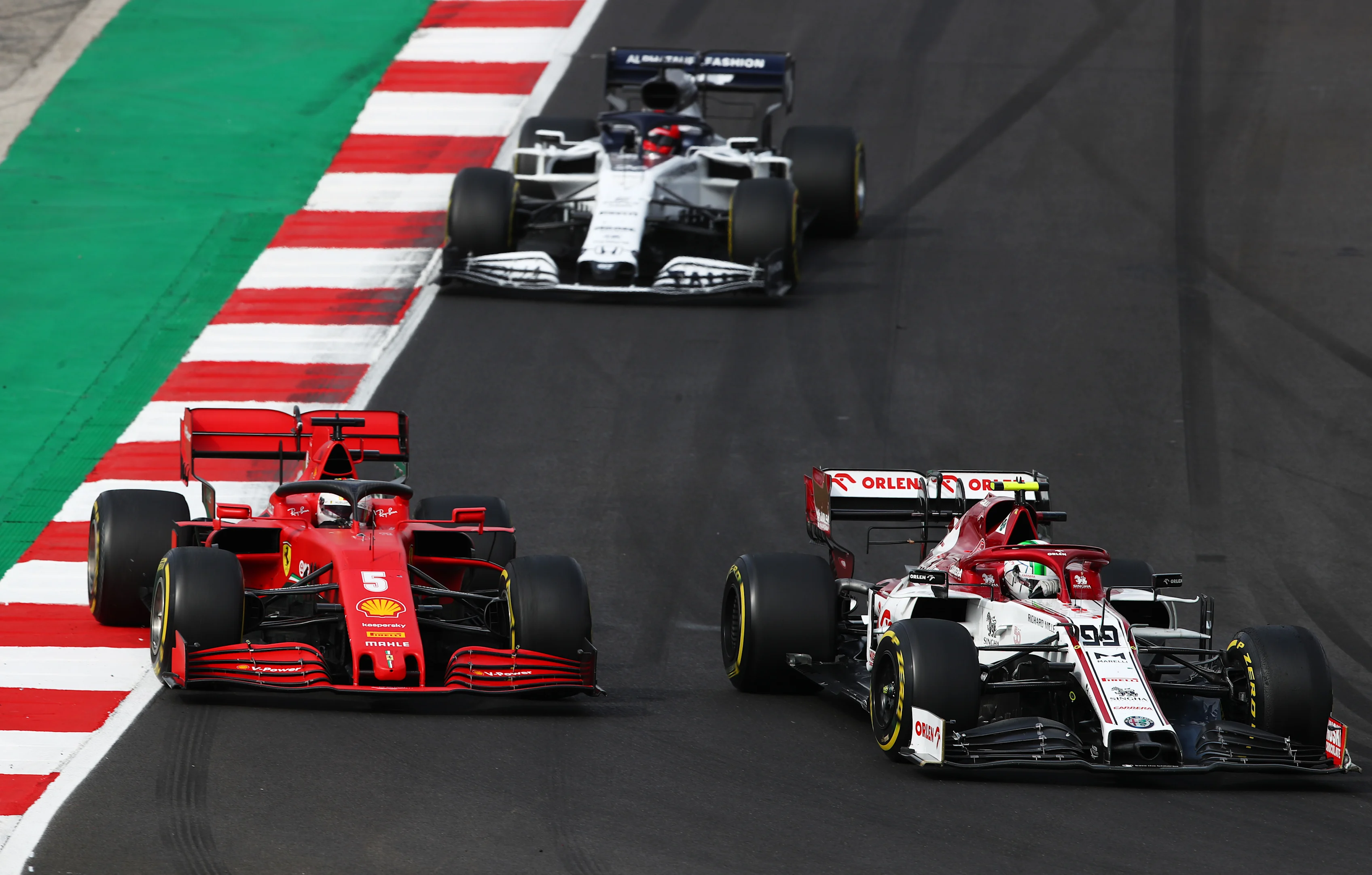 PORTIMAO, PORTUGAL - OCTOBER 25: Sebastian Vettel of Germany driving the (5) Scuderia Ferrari SF1000 and Antonio Giovinazzi of Italy driving the (99) Alfa Romeo Racing C39 Ferrari battle for position on track during the F1 Grand Prix of Portugal at Autodromo Internacional do Algarve on October 25, 2020 in Portimao, Portugal. (Photo by Joe Portlock/Getty Images)