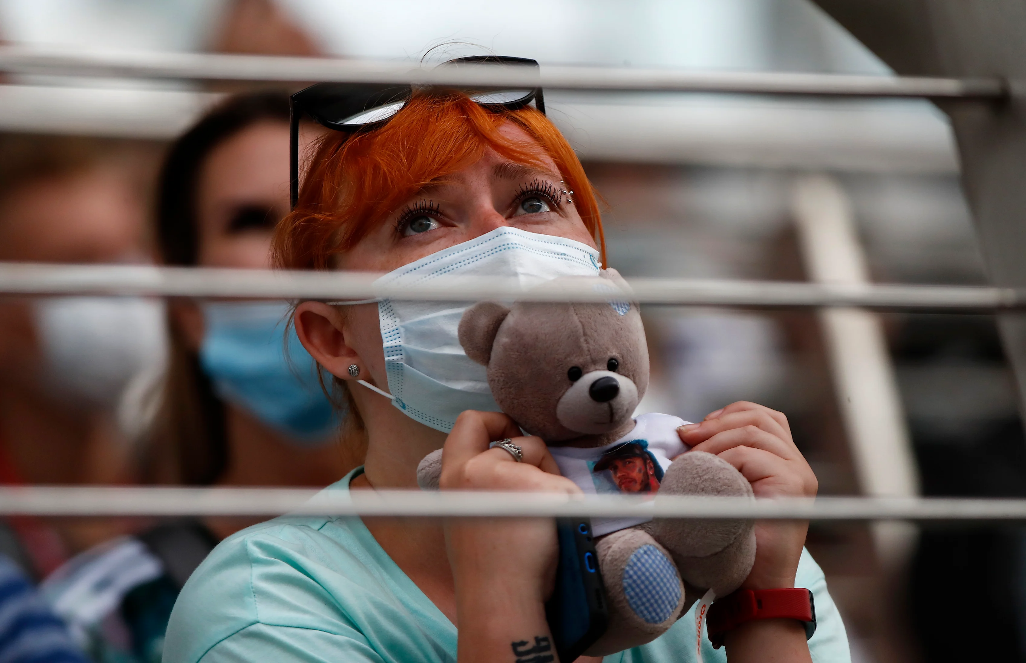 SOCHI, RUSSIA - SEPTEMBER 26: A fan holds a teddy bear as they watch the action during qualifying