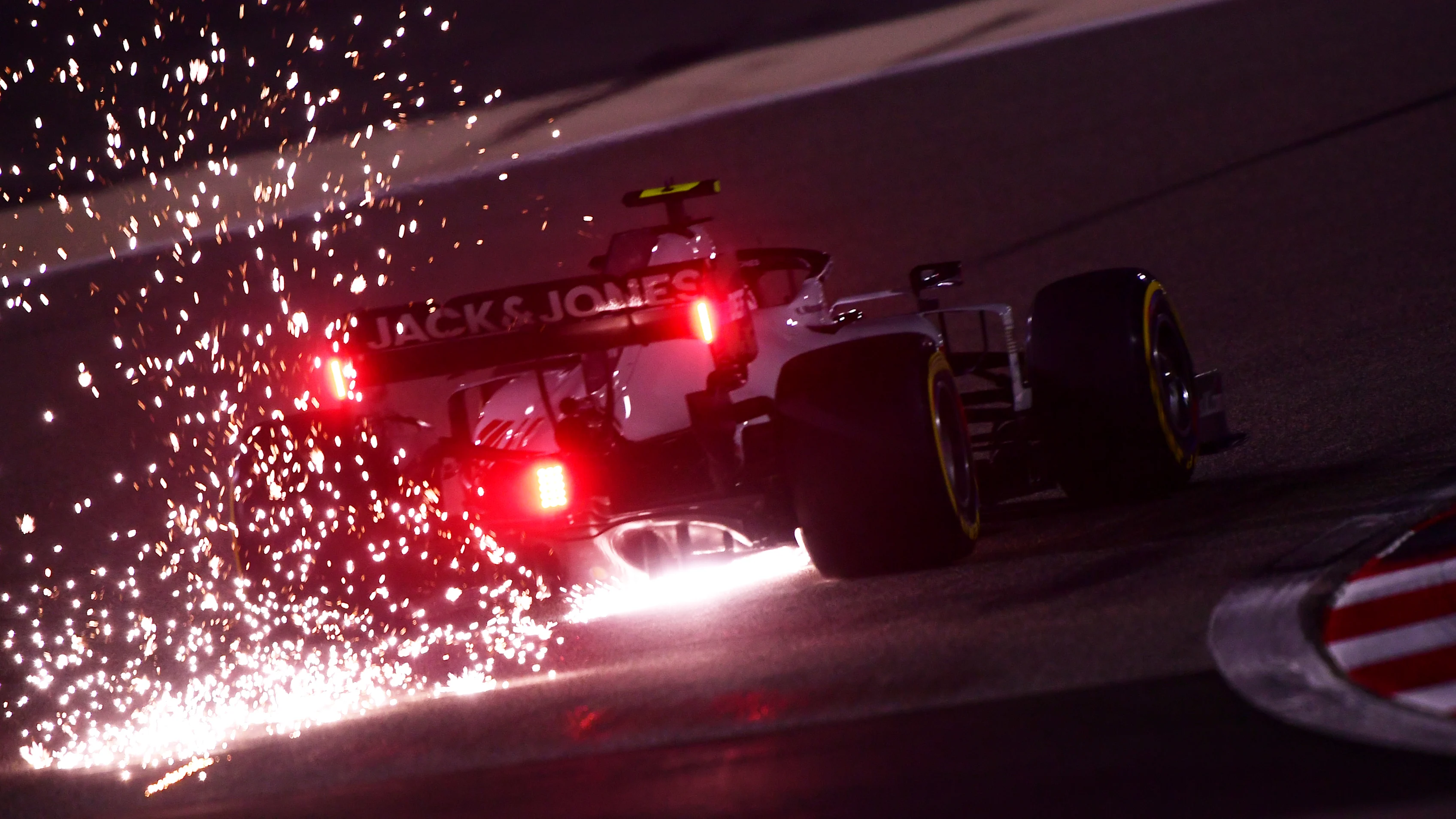 BAHRAIN, BAHRAIN - DECEMBER 04: Sparks fly behind Kevin Magnussen of Denmark driving the (20) Haas F1 Team VF-20 Ferrari during practice ahead of the F1 Grand Prix of Sakhir at Bahrain International Circuit on December 04, 2020 in Bahrain, Bahrain. (Photo by Mario Renzi - Formula 1/Formula 1 via Getty Images)