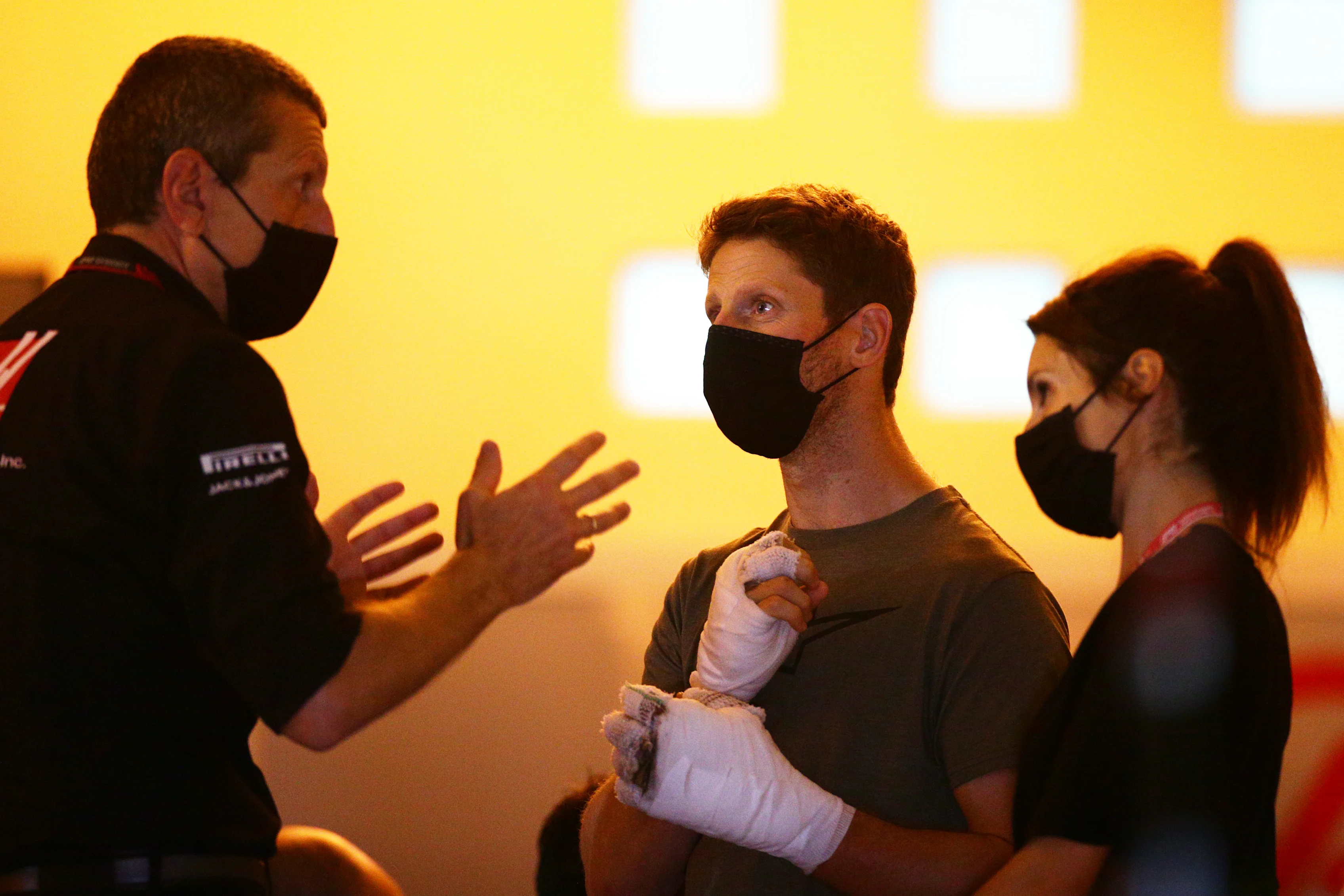 BAHRAIN, BAHRAIN - DECEMBER 03: Romain Grosjean of France and Haas F1 talks with Haas F1 Team