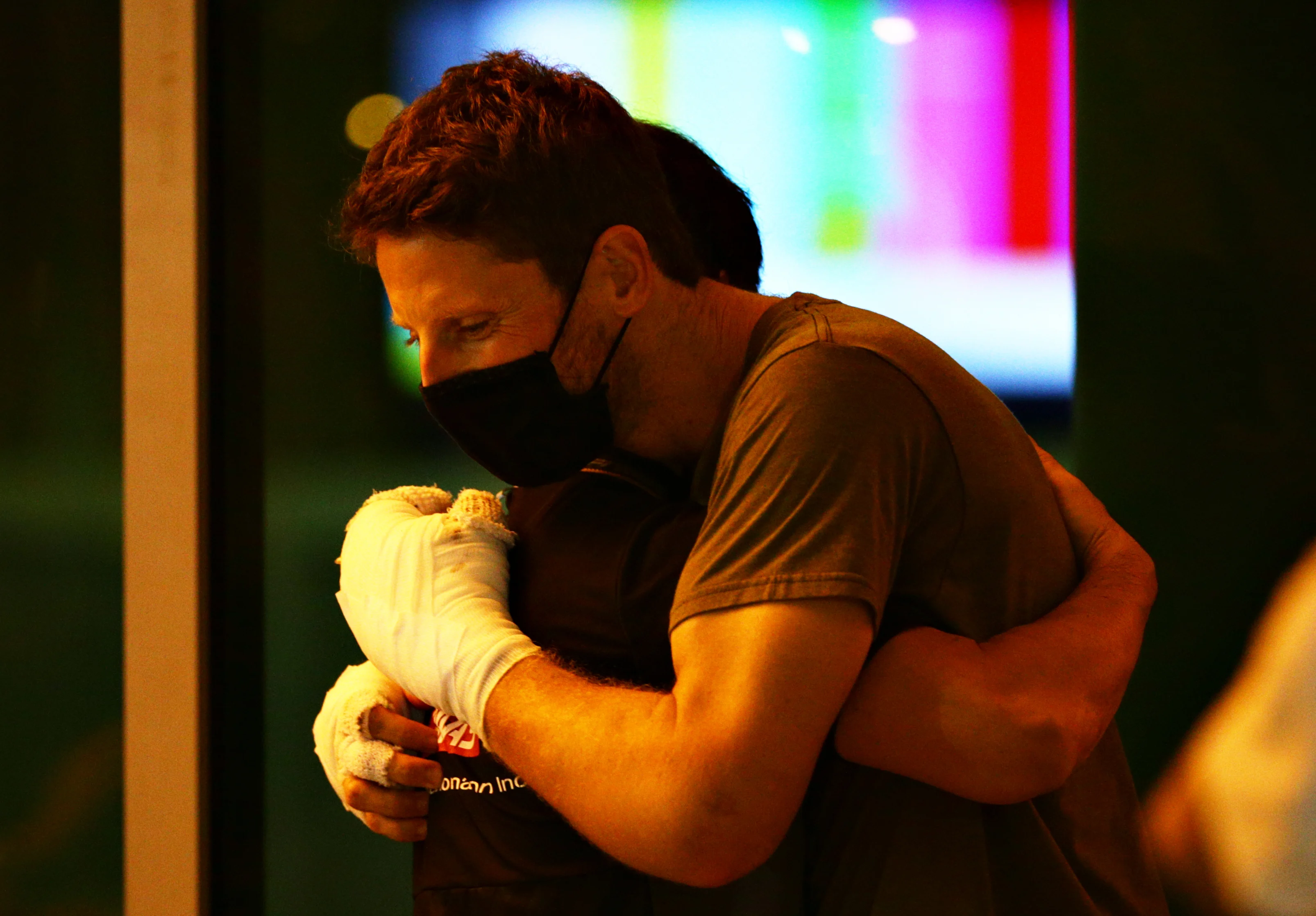 BAHRAIN, BAHRAIN - DECEMBER 03: Romain Grosjean of France and Haas F1 is hugged in the Paddock