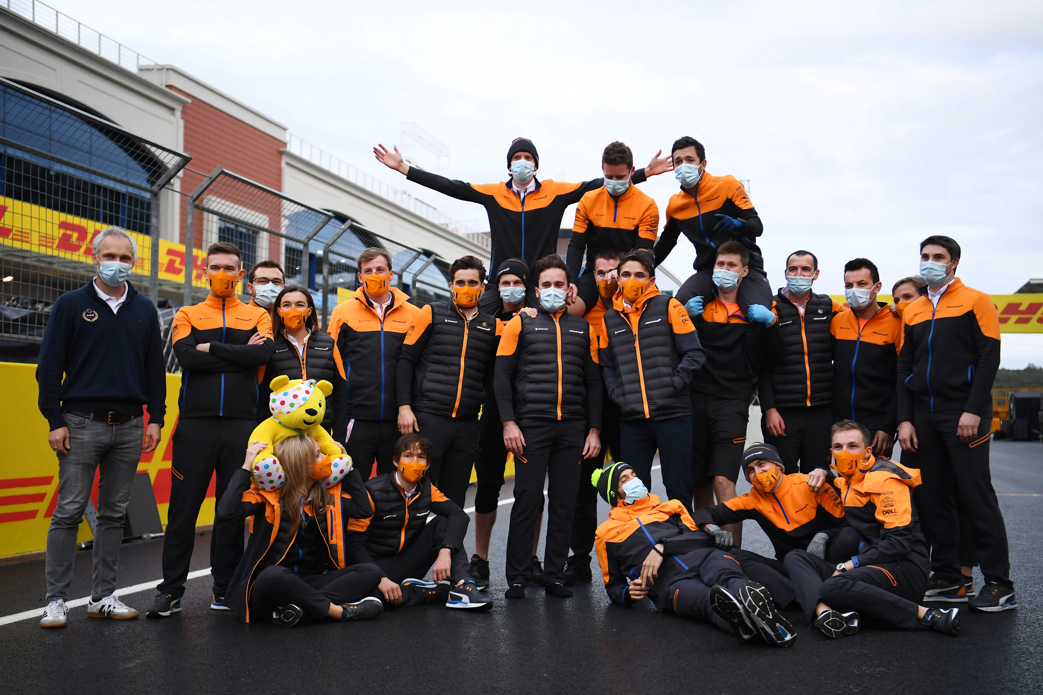 ISTANBUL, TURKEY - NOVEMBER 15: Lando Norris of Great Britain and McLaren F1 and team members pose with a Pudsey Bear toy on the grid after the F1 Grand Prix of Turkey at Intercity Istanbul Park on November 15, 2020 in Istanbul, Turkey. (Photo by Clive Mason/Getty Images)