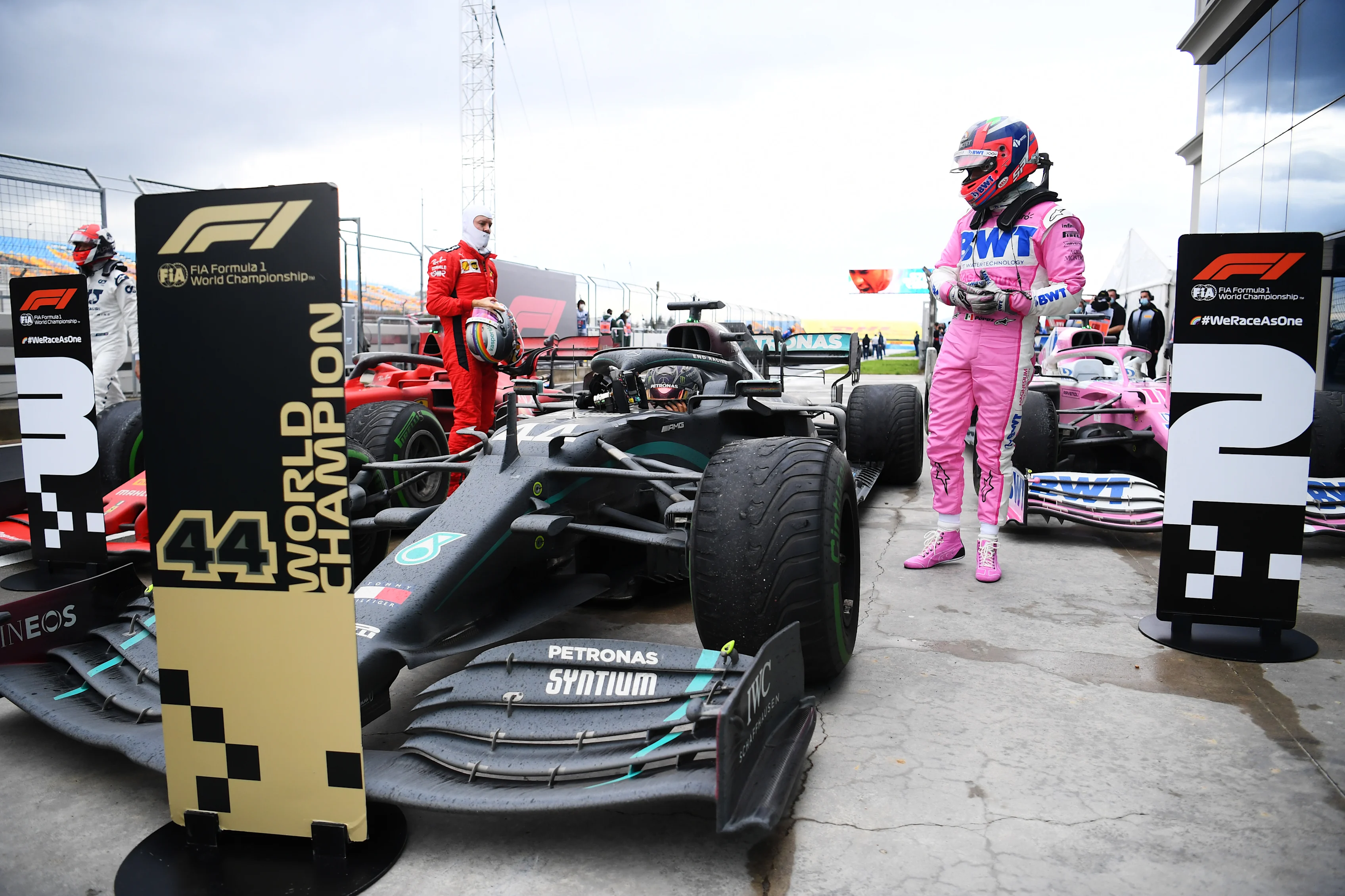 ISTANBUL, TURKEY - NOVEMBER 15: Race winner Lewis Hamilton of Great Britain and Mercedes GP is congratulated by Sebastian Vettel of Germany and Ferrari and Sergio Perez of Mexico and Racing Point in parc ferme after winning a 7th F1 World Drivers Championship during the F1 Grand Prix of Turkey at Intercity Istanbul Park on November 15, 2020 in Istanbul, Turkey. (Photo by Clive Mason/Getty Images)