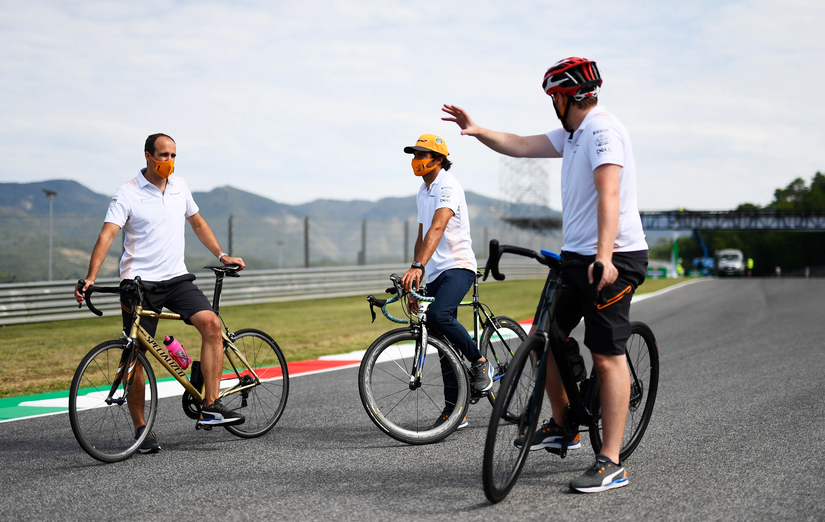 SCARPERIA, ITALY - SEPTEMBER 10: Carlos Sainz of Spain and McLaren F1 rides a bicycle on the track