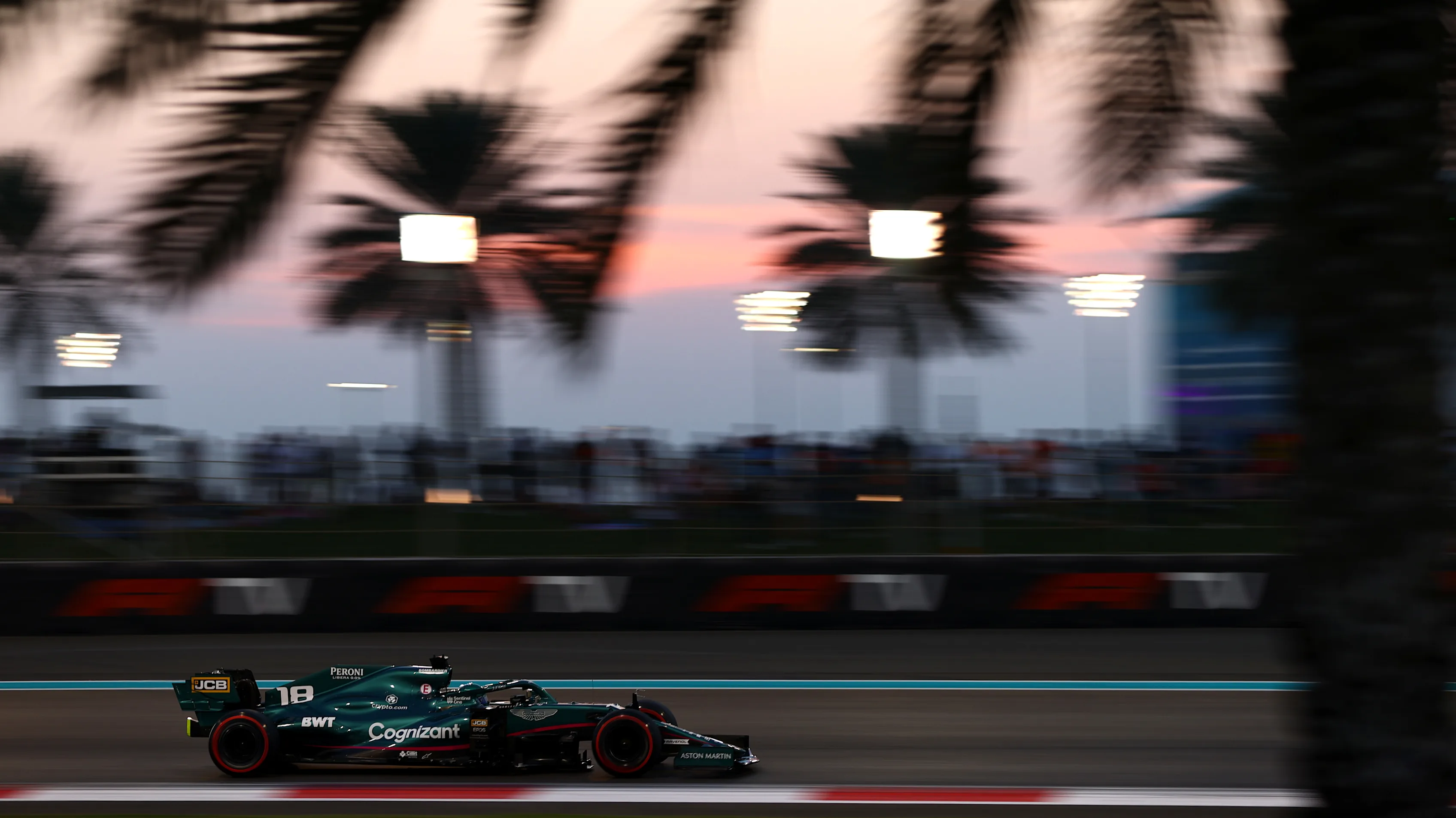 ABU DHABI, UNITED ARAB EMIRATES - DECEMBER 11: Lance Stroll of Canada driving the (18) Aston Martin AMR21 Mercedes during qualifying ahead of the F1 Grand Prix of Abu Dhabi at Yas Marina Circuit on December 11, 2021 in Abu Dhabi, United Arab Emirates. (Photo by Dan Istitene - Formula 1/Formula 1 via Getty Images)