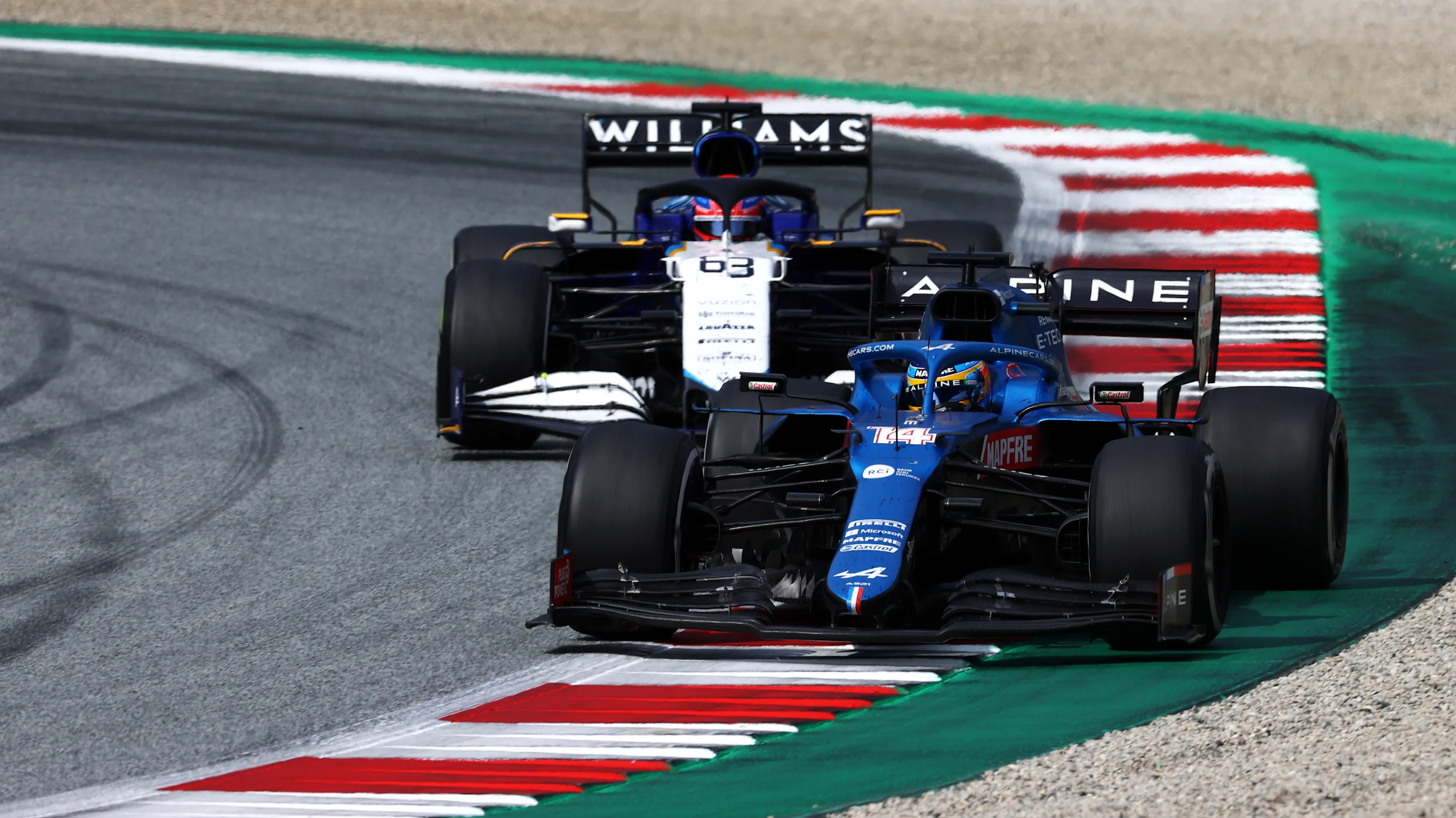 SPIELBERG, AUSTRIA - JULY 04: Fernando Alonso of Spain driving the (14) Alpine A521 Renault leads George Russell of Great Britain driving the (63) Williams Racing FW43B Mercedes during the F1 Grand Prix of Austria at Red Bull Ring on July 04, 2021 in Spielberg, Austria. (Photo by Clive Mason - Formula 1/Formula 1 via Getty Images)