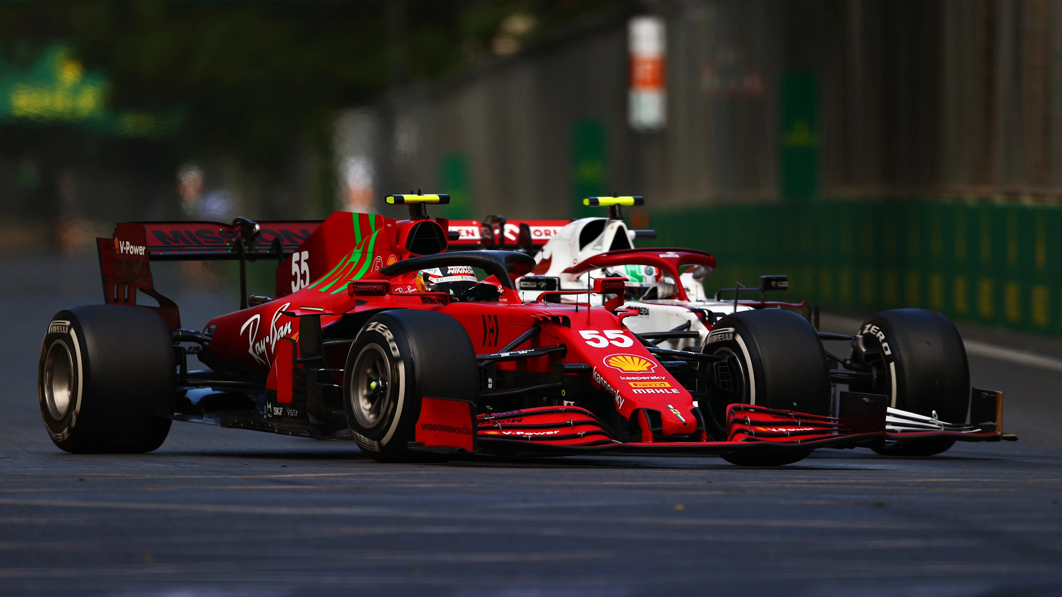 BAKU, AZERBAIJAN - JUNE 06: Carlos Sainz of Spain driving the (55) Scuderia Ferrari SF21 and Antonio Giovinazzi of Italy driving the (99) Alfa Romeo Racing C41 Ferrari battle for track position during the F1 Grand Prix of Azerbaijan at Baku City Circuit on June 06, 2021 in Baku, Azerbaijan. (Photo by Dan Istitene - Formula 1/Formula 1 via Getty Images)