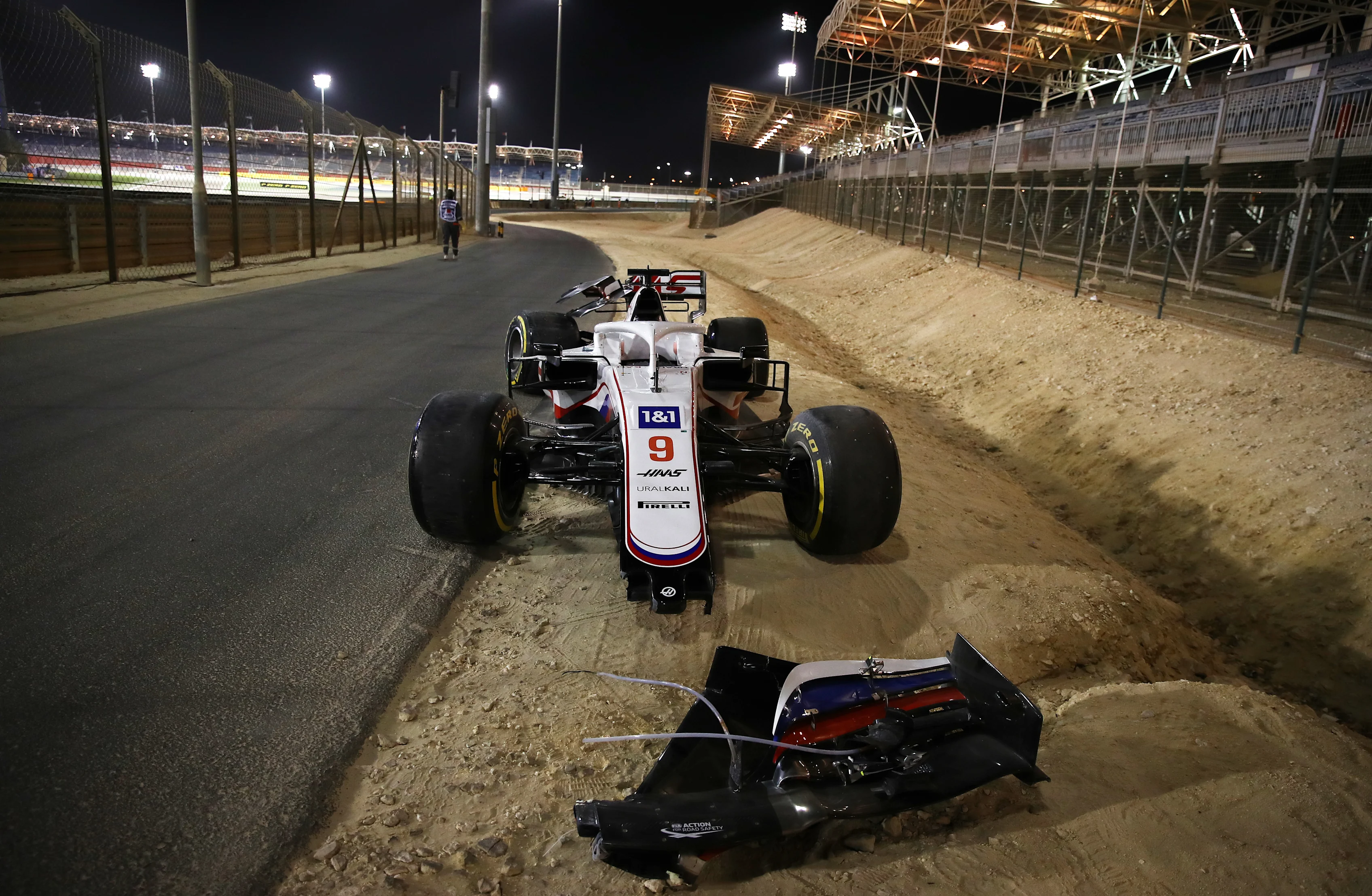 BAHRAIN, BAHRAIN - MARCH 28: The abandoned car of Nikita Mazepin of Russia and Haas F1 is seen at the side of the track after a colllision earlier in the race during the F1 Grand Prix of Bahrain at Bahrain International Circuit on March 28, 2021 in Bahrain, Bahrain. (Photo by Bryn Lennon/Getty Images)