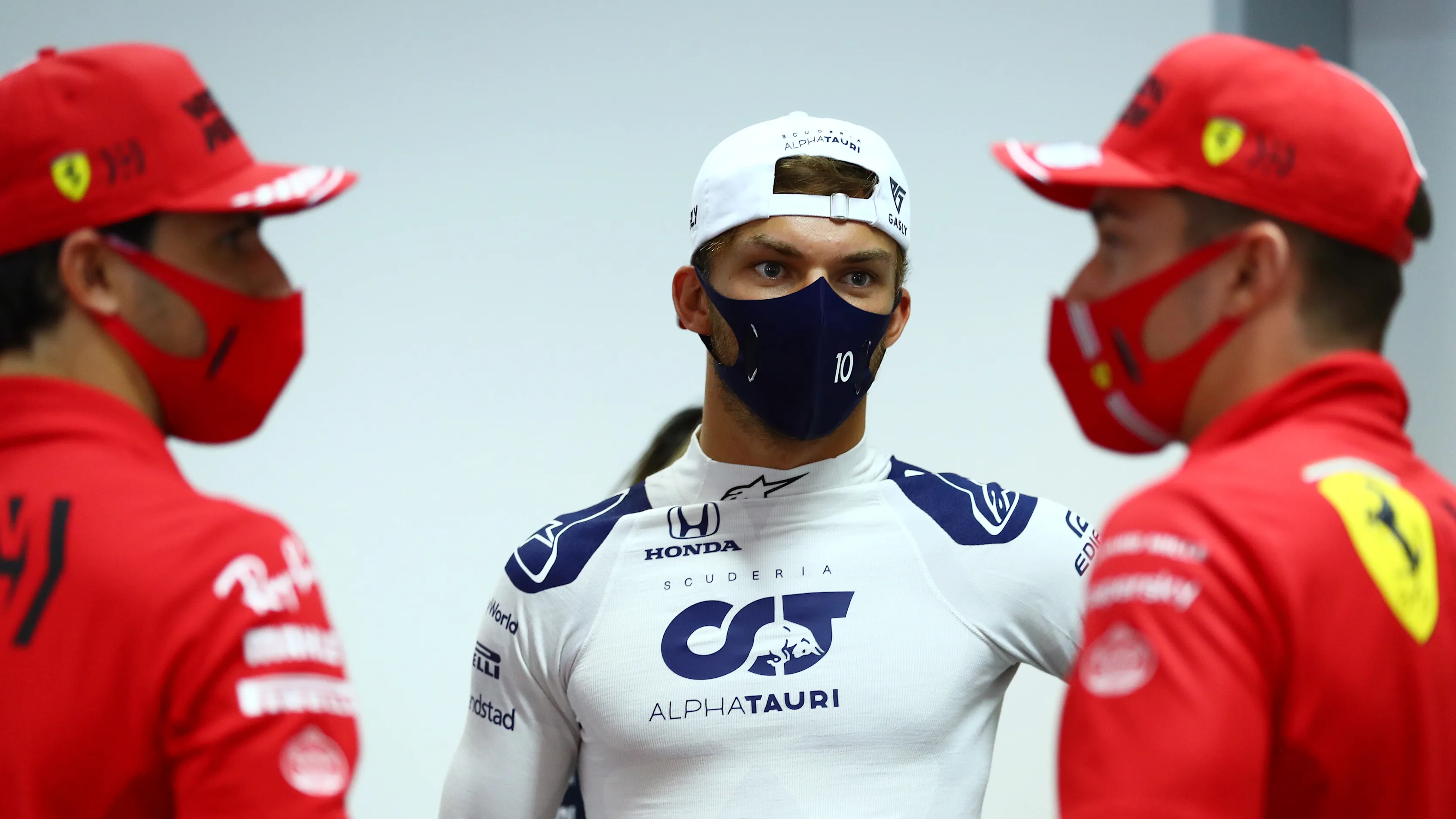 BAHRAIN, BAHRAIN - MARCH 25: Pierre Gasly of France and Scuderia AlphaTauri talks with Carlos Sainz