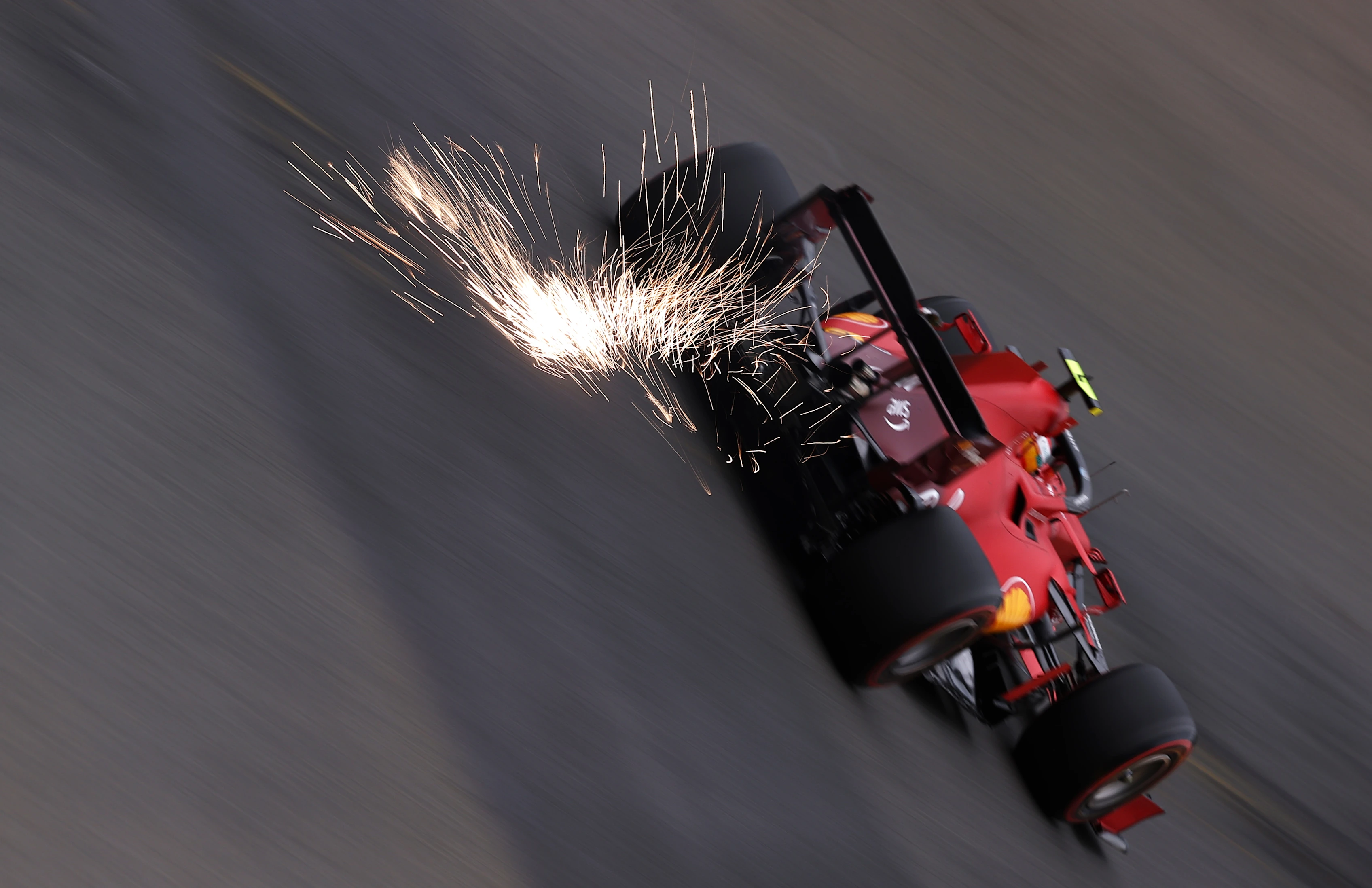 SPA, BELGIUM - AUGUST 27: Sparks fly behind Carlos Sainz of Spain driving the (55) Scuderia Ferrari SF21 during practice ahead of the F1 Grand Prix of Belgium at Circuit de Spa-Francorchamps on August 27, 2021 in Spa, Belgium. (Photo by Lars Baron/Getty Images)