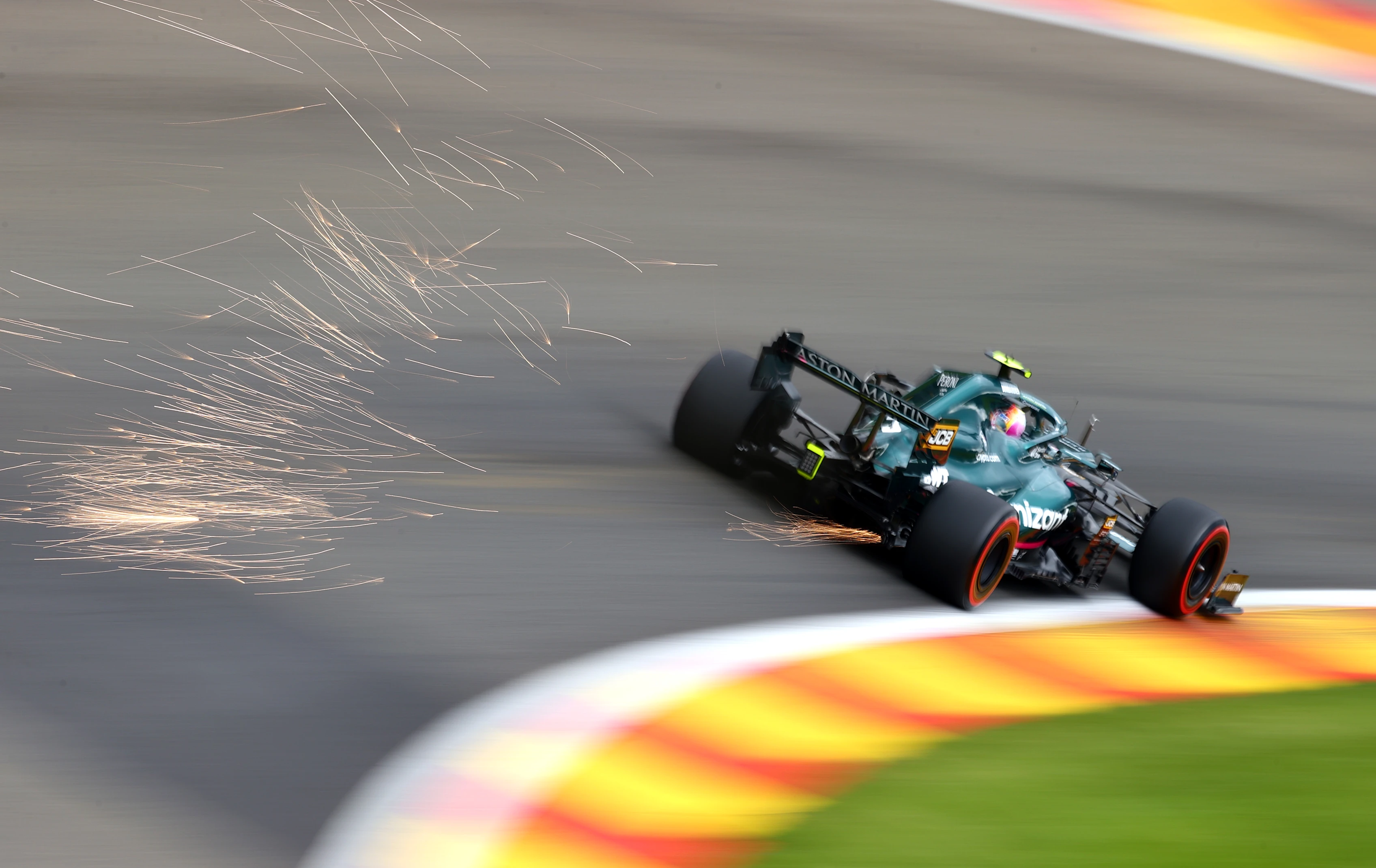 SPA, BELGIUM - AUGUST 27: Sparks fly behind Sebastian Vettel of Germany driving the (5) Aston