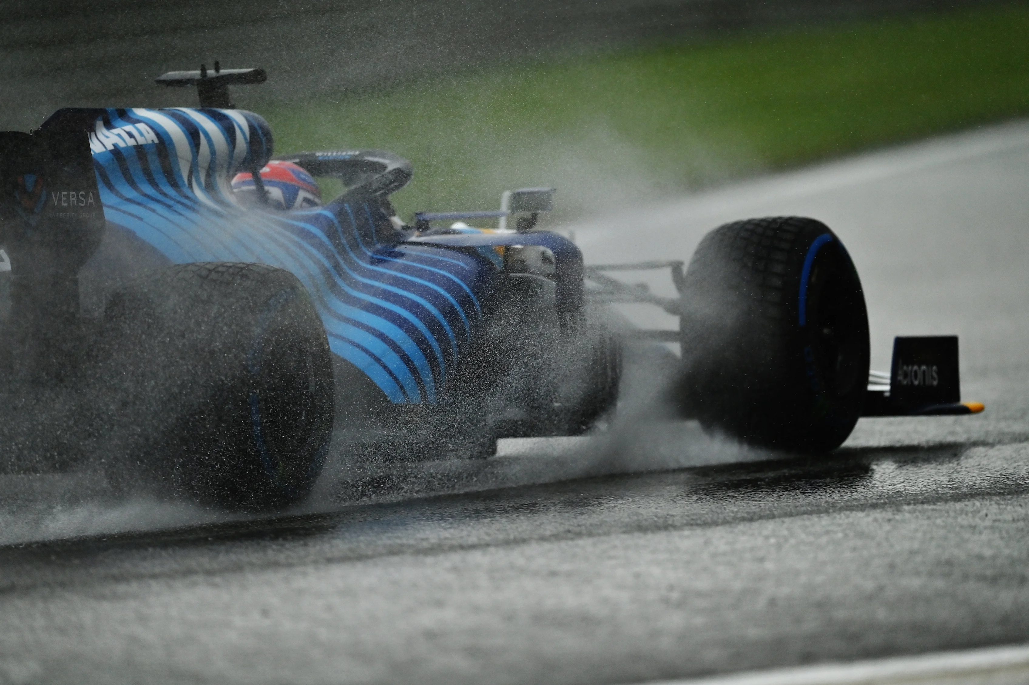 SPA, BELGIUM - AUGUST 28: Rain sprays around George Russell of Great Britain driving the (63)