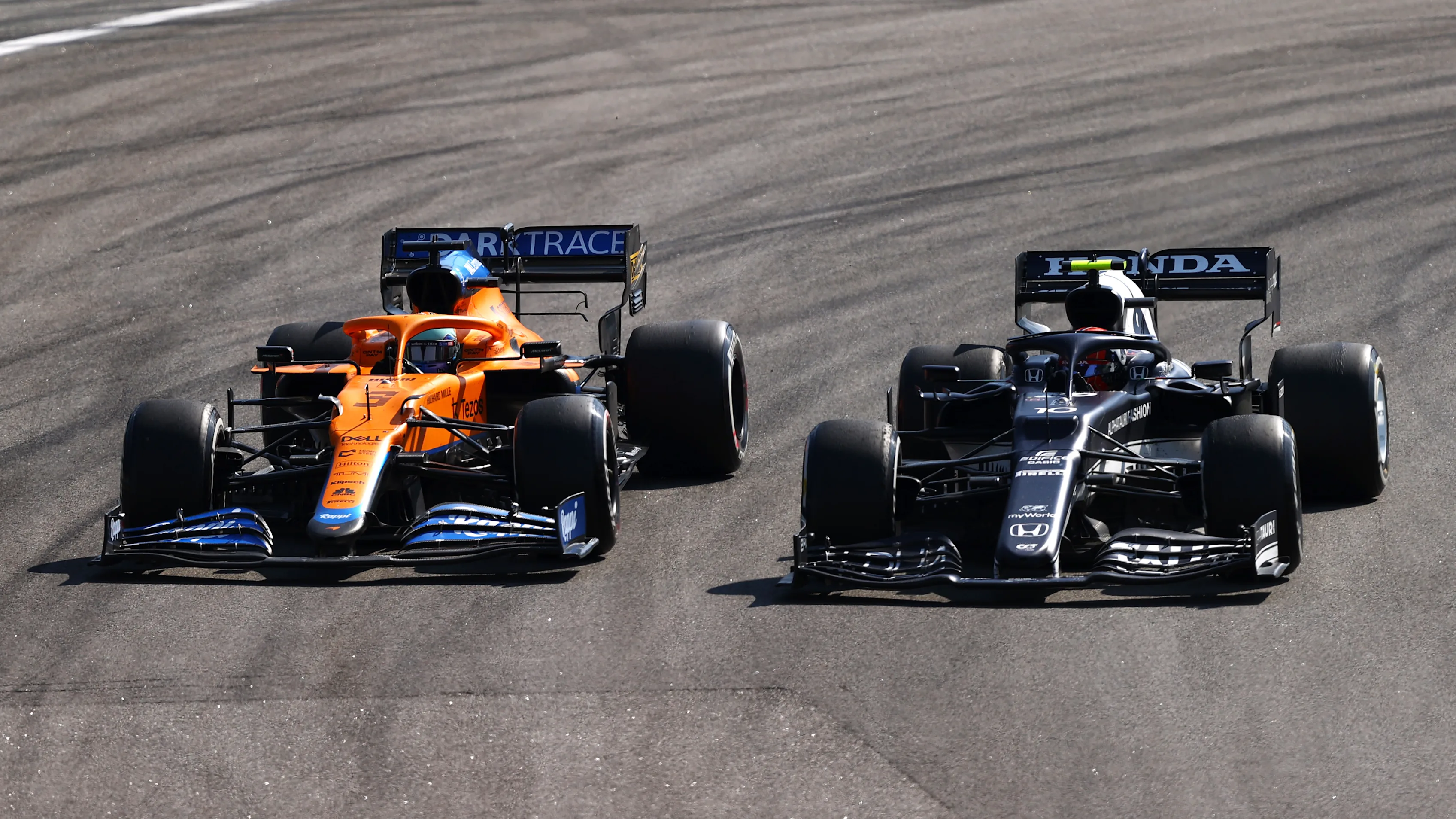 SAO PAULO, BRAZIL - NOVEMBER 14: Pierre Gasly of France driving the (10) Scuderia AlphaTauri AT02 Honda leads Daniel Ricciardo of Australia driving the (3) McLaren F1 Team MCL35M Mercedes during the F1 Grand Prix of Brazil at Autodromo Jose Carlos Pace on November 14, 2021 in Sao Paulo, Brazil. (Photo by Bryn Lennon - Formula 1/Formula 1 via Getty Images)