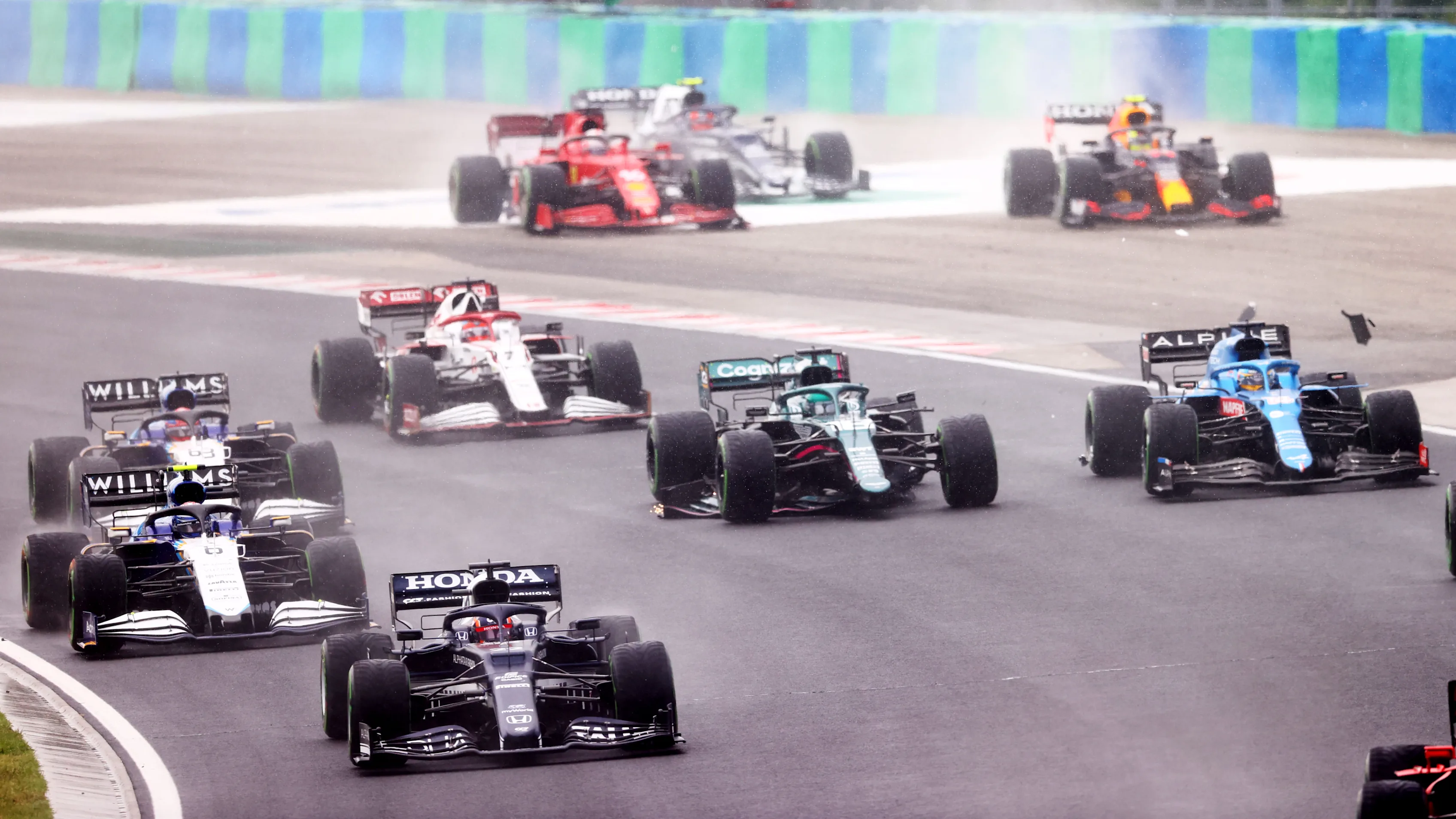BUDAPEST, HUNGARY - AUGUST 01: Yuki Tsunoda of Japan driving the (22) Scuderia AlphaTauri AT02 Honda round turn one at the start during the F1 Grand Prix of Hungary at Hungaroring on August 01, 2021 in Budapest, Hungary. (Photo by Dan Istitene - Formula 1/Formula 1 via Getty Images)