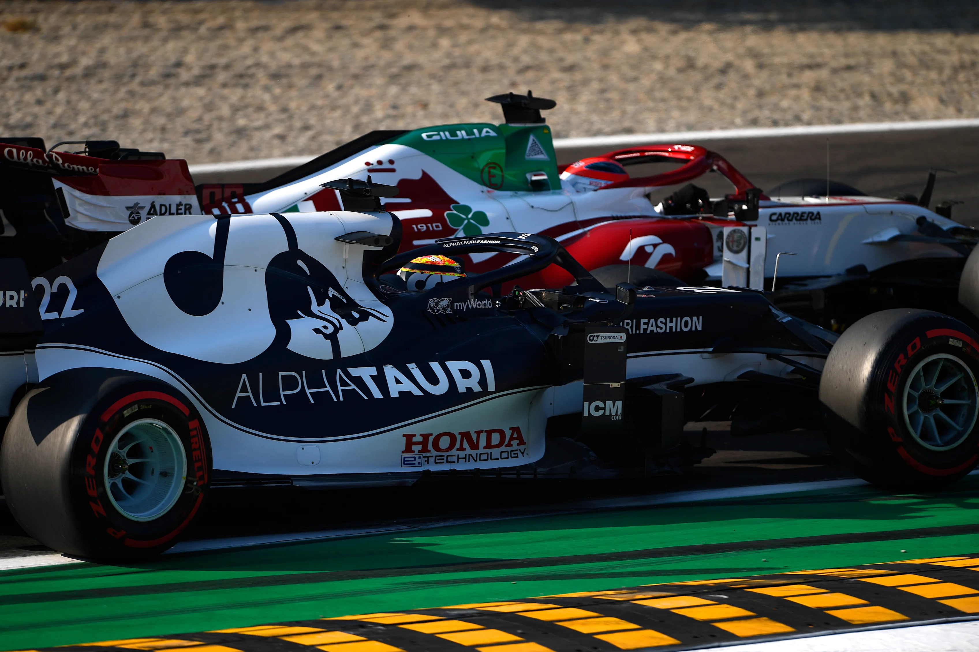 MONZA, ITALY - SEPTEMBER 11: Robert Kubica of Poland driving the (88) Alfa Romeo Racing C41 Ferrari and Yuki Tsunoda of Japan driving the (22) Scuderia AlphaTauri AT02 Honda battle for position during the Sprint ahead of the F1 Grand Prix of Italy at Autodromo di Monza on September 11, 2021 in Monza, Italy. (Photo by Rudy Carezzevoli/Getty Images)