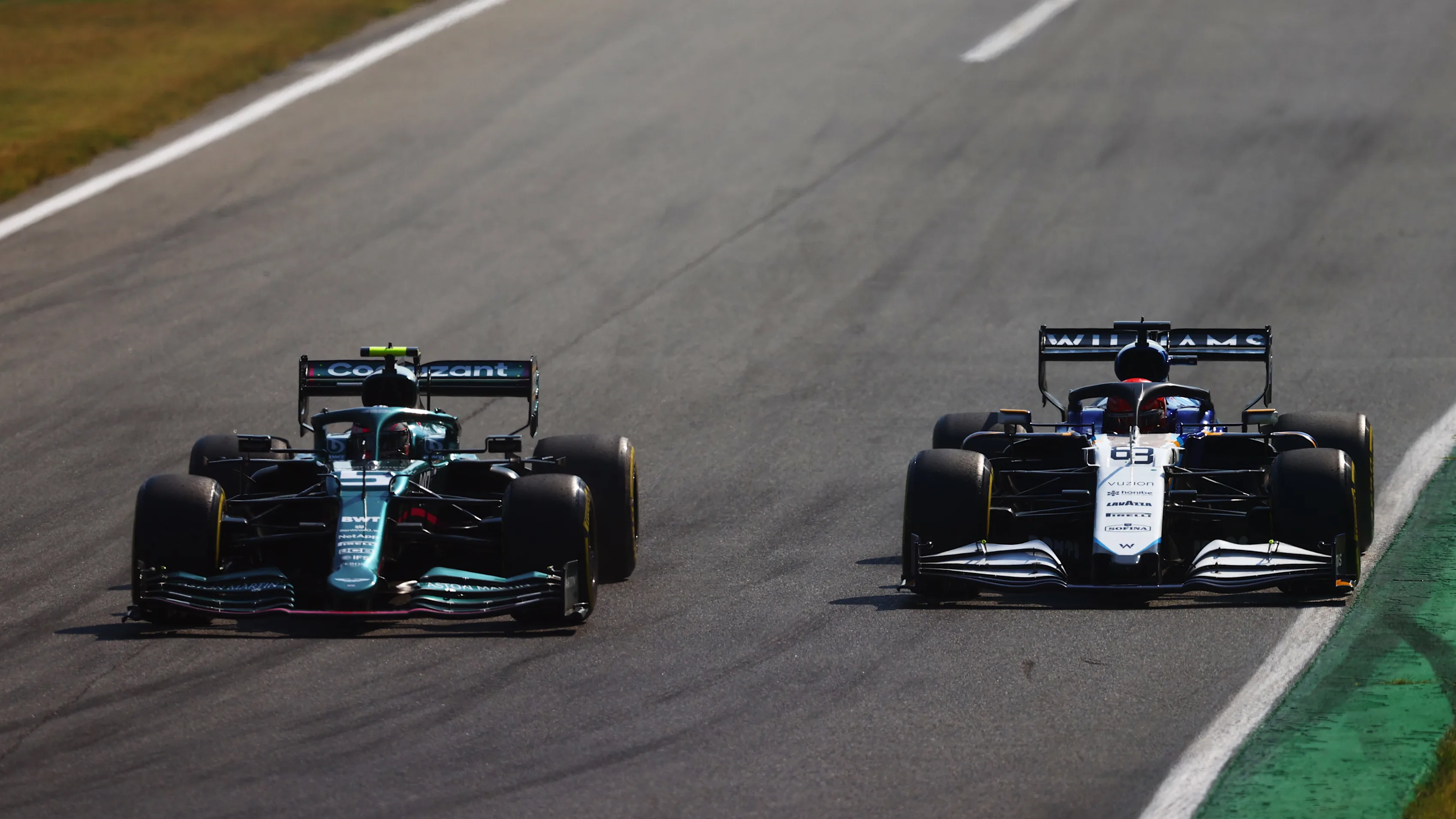 MONZA, ITALY - SEPTEMBER 12: Sebastian Vettel of Germany driving the (5) Aston Martin AMR21 Mercedes and George Russell of Great Britain driving the (63) Williams Racing FW43B Mercedes on track during the F1 Grand Prix of Italy at Autodromo di Monza on September 12, 2021 in Monza, Italy. (Photo by Dan Istitene - Formula 1/Formula 1 via Getty Images)