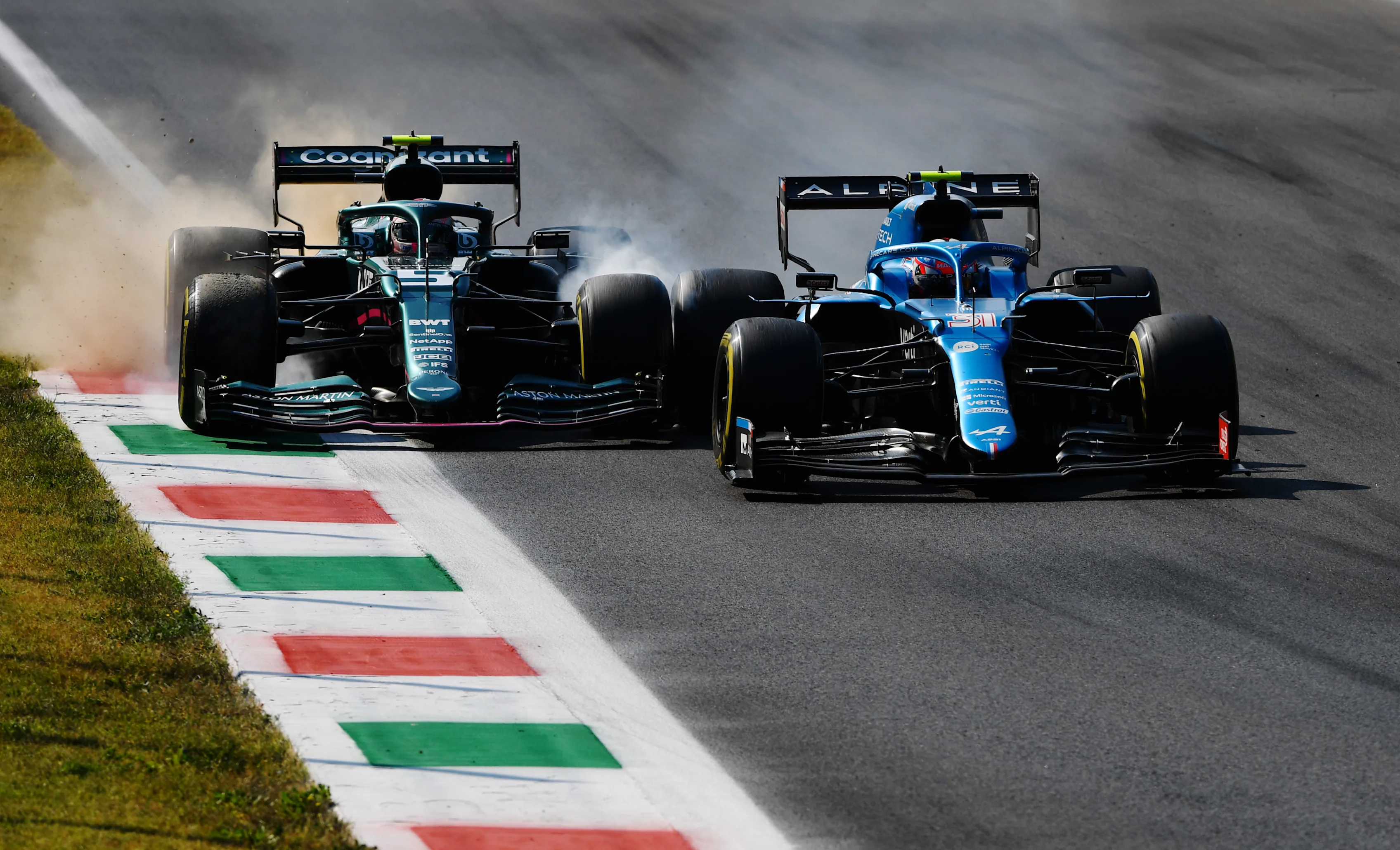 MONZA, ITALY - SEPTEMBER 12: Esteban Ocon of France driving the (31) Alpine A521 Renault and Sebastian Vettel of Germany driving the (5) Aston Martin AMR21 Mercedes collide during the F1 Grand Prix of Italy at Autodromo di Monza on September 12, 2021 in Monza, Italy. (Photo by Rudy Carezzevoli/Getty Images)