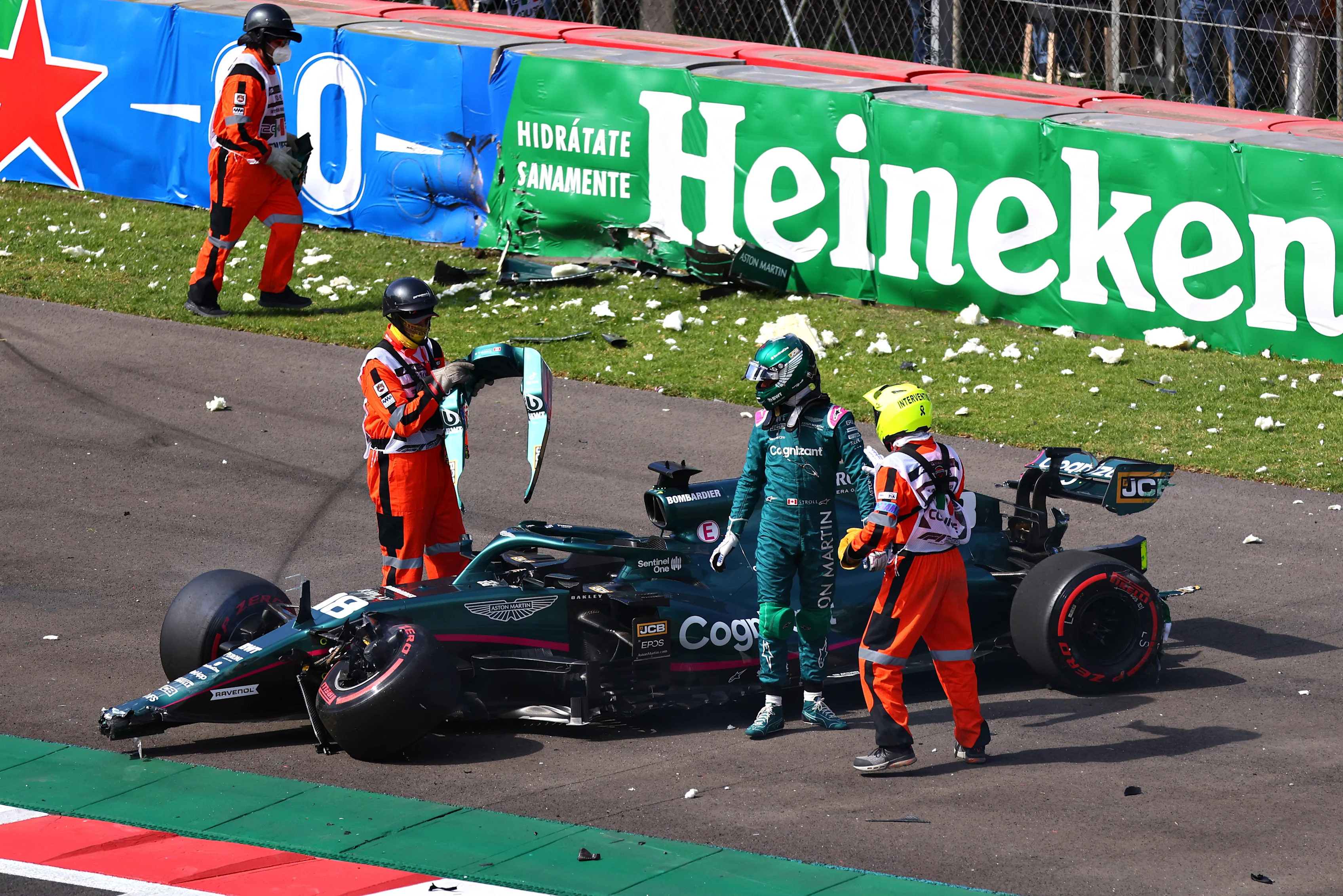 MEXICO CITY, MEXICO - NOVEMBER 06: Lance Stroll of Canada driving the (18) Aston Martin AMR21 Mercedes looks over his car after crashing during qualifying ahead of the F1 Grand Prix of Mexico at Autodromo Hermanos Rodriguez on November 06, 2021 in Mexico City, Mexico. (Photo by Hector Vivas - Formula 1/Formula 1 via Getty Images)