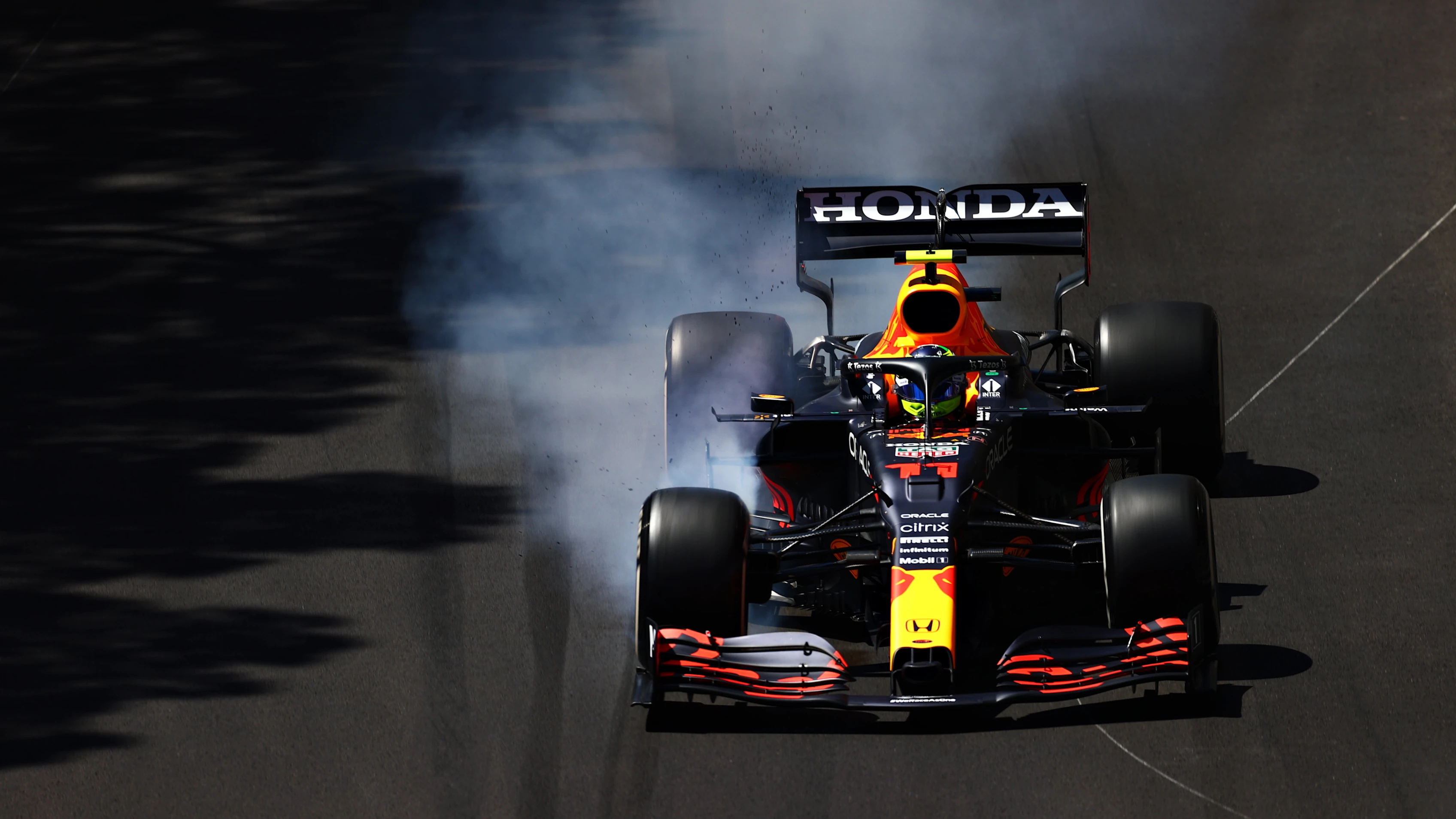 MONTE-CARLO, MONACO - MAY 20: Sergio Perez of Mexico driving the (11) Red Bull Racing RB16B Honda locks a wheel under braking during practice ahead of the F1 Grand Prix of Monaco at Circuit de Monaco on May 20, 2021 in Monte-Carlo, Monaco. (Photo by Dan Istitene - Formula 1/Formula 1 via Getty Images)