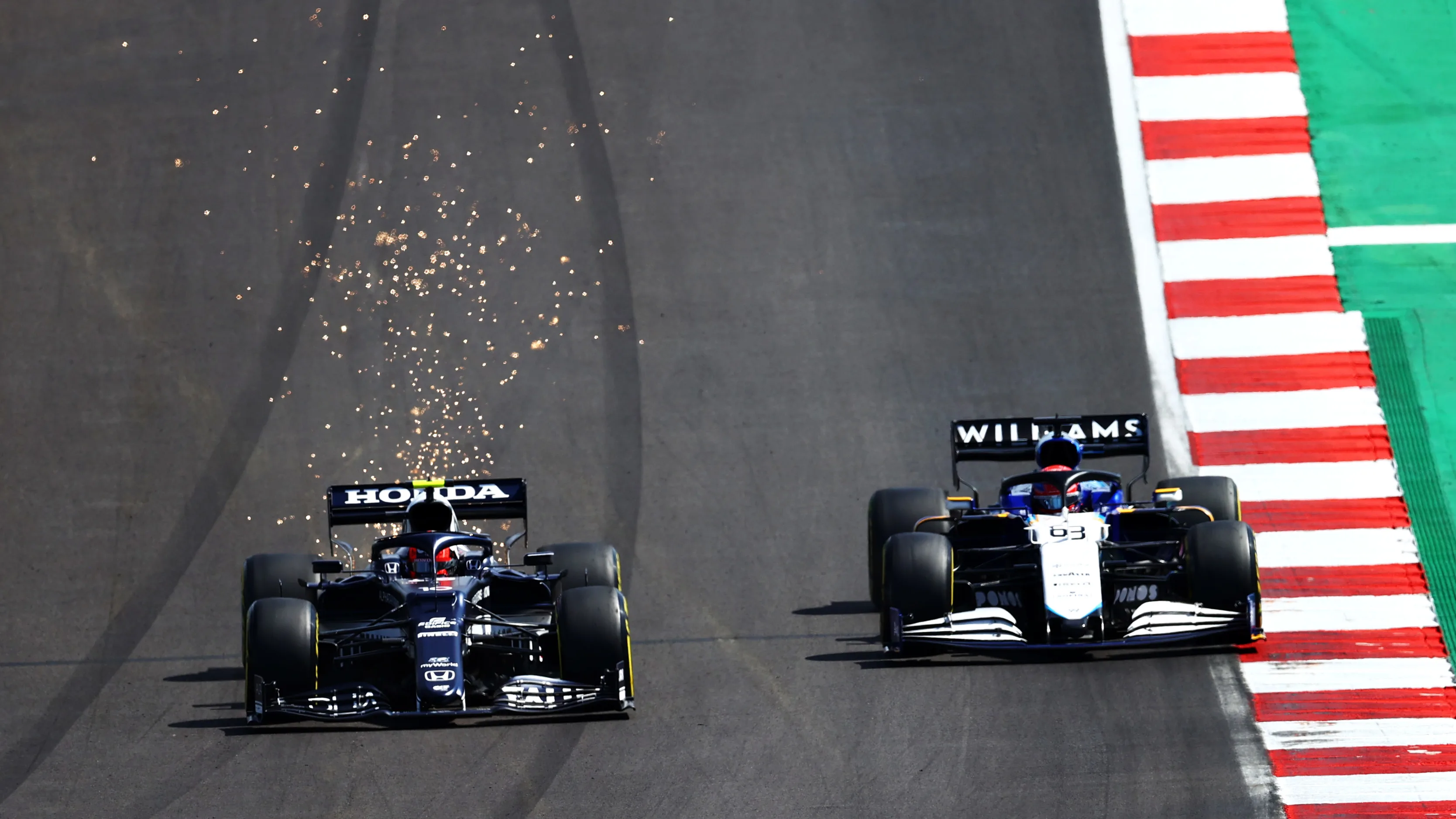 PORTIMAO, PORTUGAL - MAY 02: Pierre Gasly of France driving the (10) Scuderia AlphaTauri AT02 Honda overtakes George Russell of Great Britain driving the (63) Williams Racing FW43B Mercedes during the F1 Grand Prix of Portugal at Autodromo Internacional Do Algarve on May 02, 2021 in Portimao, Portugal. (Photo by Dan Istitene - Formula 1/Formula 1 via Getty Images)