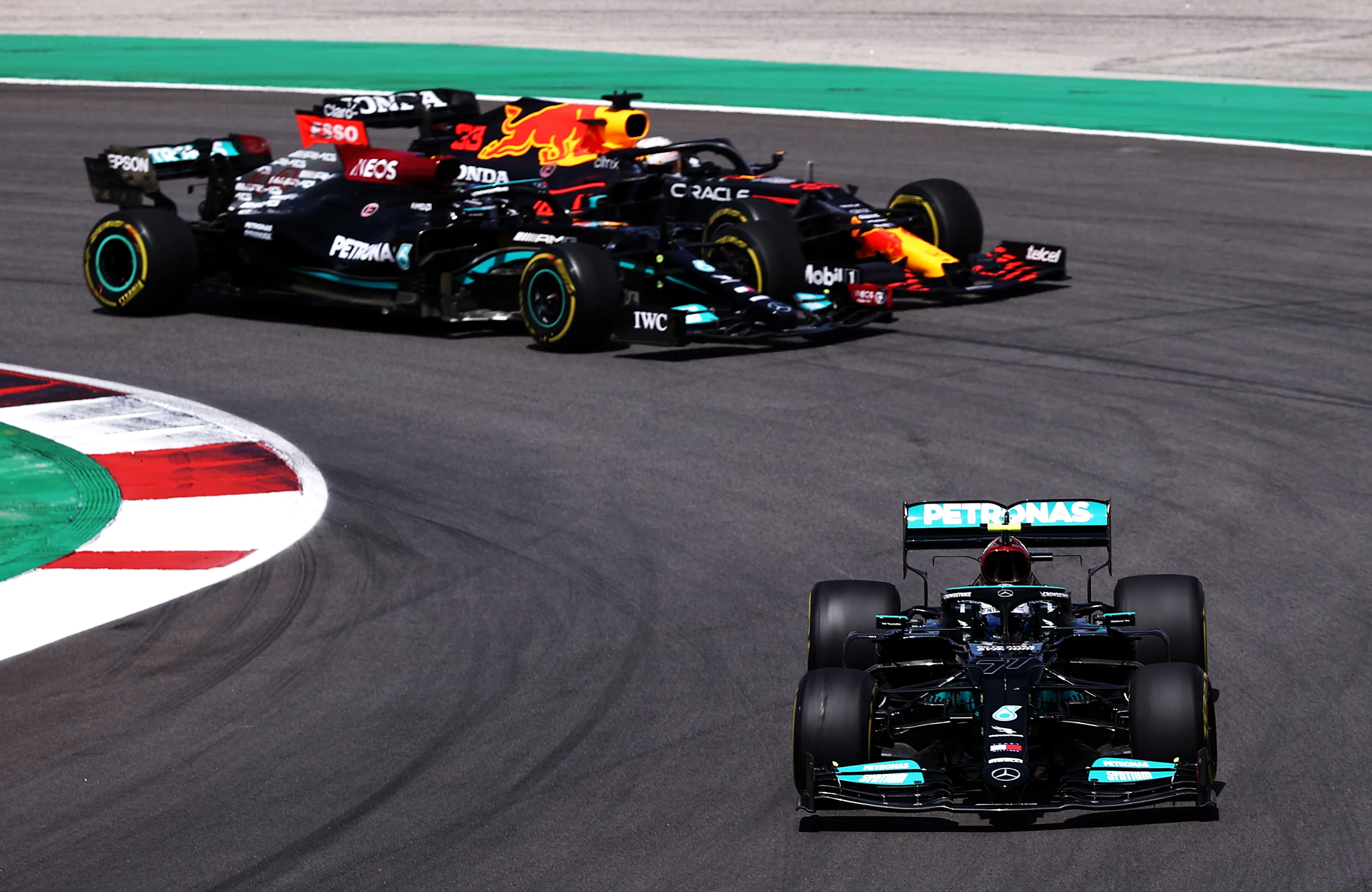 PORTIMAO, PORTUGAL - MAY 02: Valtteri Bottas of Finland driving the (77) Mercedes AMG Petronas F1 Team Mercedes W12 leads Lewis Hamilton of Great Britain driving the (44) Mercedes AMG Petronas F1 Team Mercedes W12 and Max Verstappen of the Netherlands driving the (33) Red Bull Racing RB16B Honda on track during the F1 Grand Prix of Portugal at Autodromo Internacional Do Algarve on May 02, 2021 in Portimao, Portugal. (Photo by Lars Baron/Getty Images)