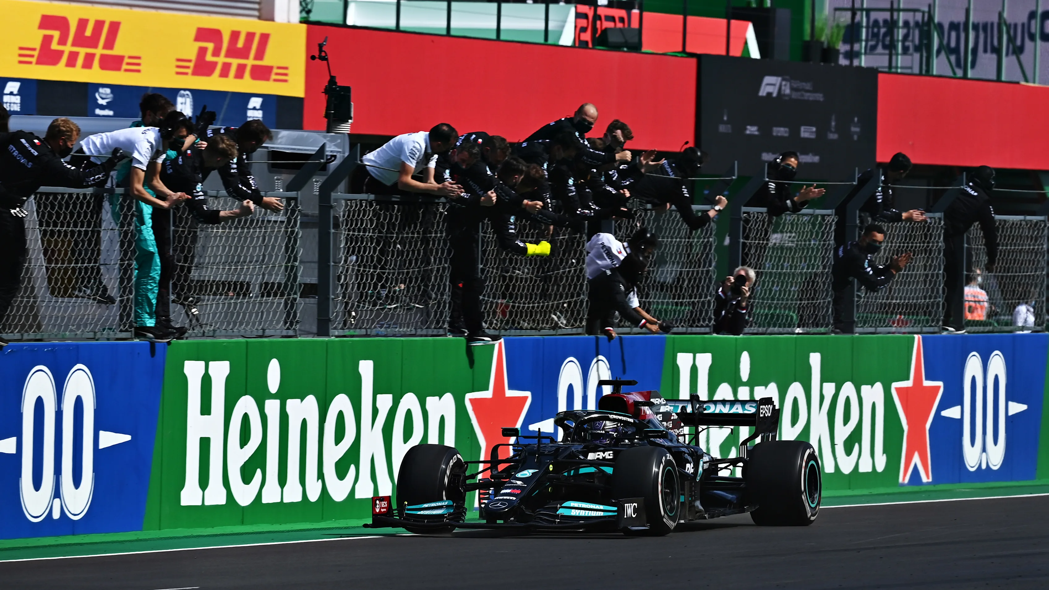 PORTIMAO, PORTUGAL - MAY 02: Mercedes GP team members celebrate on the pitwall as Lewis Hamilton of