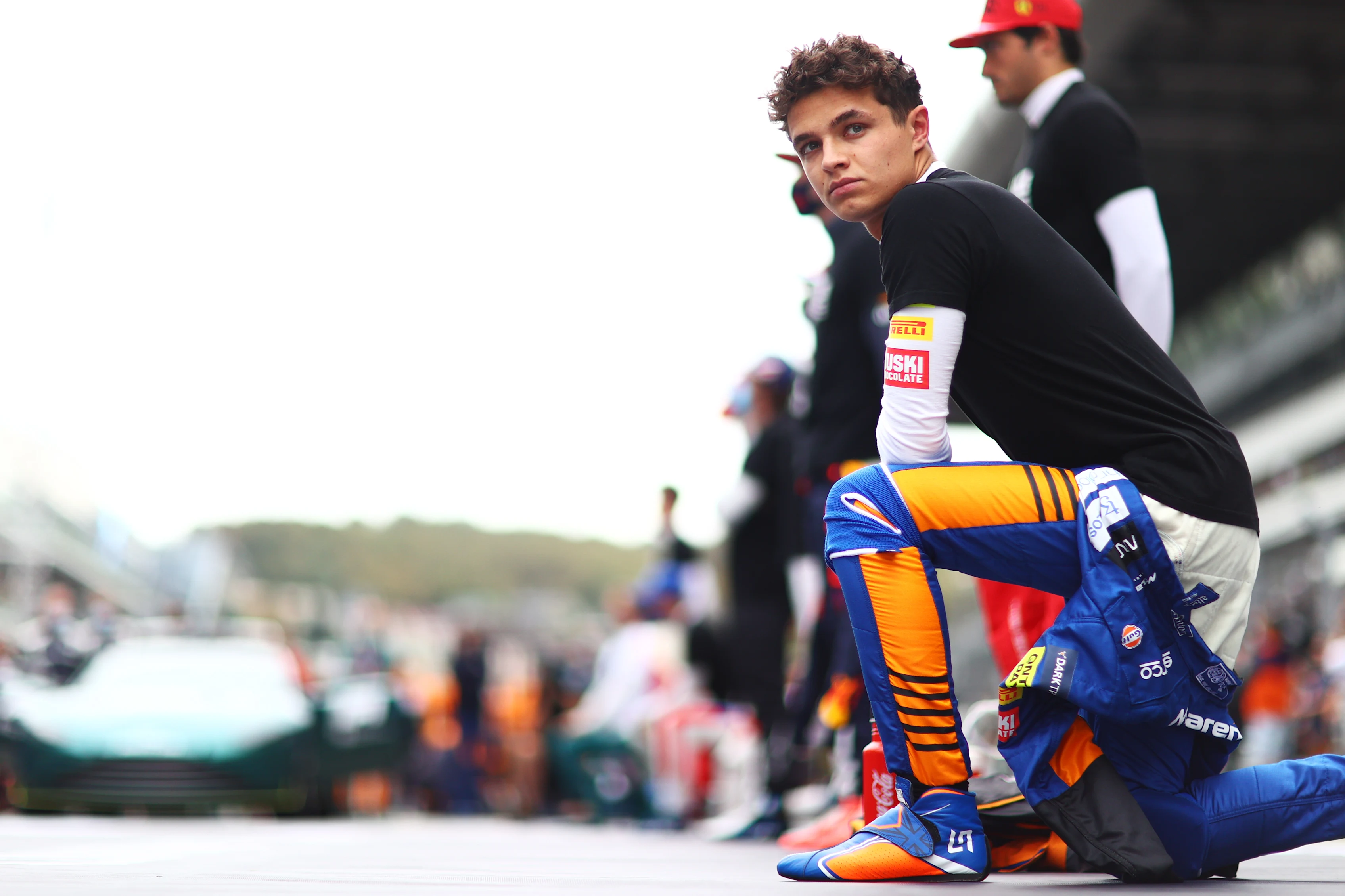 SOCHI, RUSSIA - SEPTEMBER 26: Lando Norris of Great Britain and McLaren F1 kneels in support of the We Race As One initiative before the F1 Grand Prix of Russia at Sochi Autodrom on September 26, 2021 in Sochi, Russia. (Photo by Dan Istitene - Formula 1/Formula 1 via Getty Images)