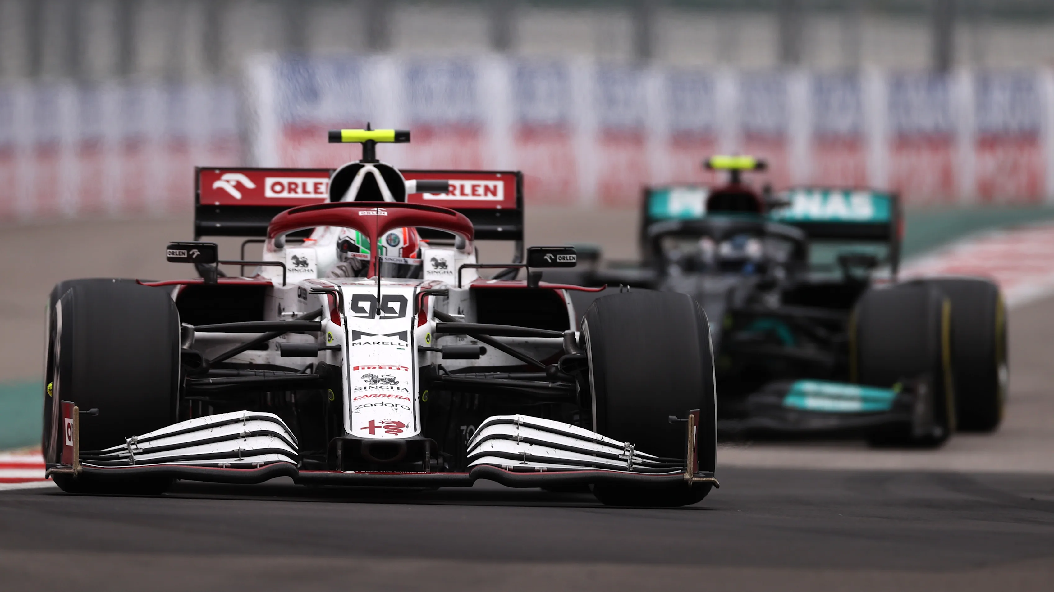 SOCHI, RUSSIA - SEPTEMBER 26: Antonio Giovinazzi of Italy driving the (99) Alfa Romeo Racing C41 Ferrari leads Valtteri Bottas of Finland driving the (77) Mercedes AMG Petronas F1 Team Mercedes W12 during the F1 Grand Prix of Russia at Sochi Autodrom on September 26, 2021 in Sochi, Russia. (Photo by Lars Baron - Formula 1/Formula 1 via Getty Images)