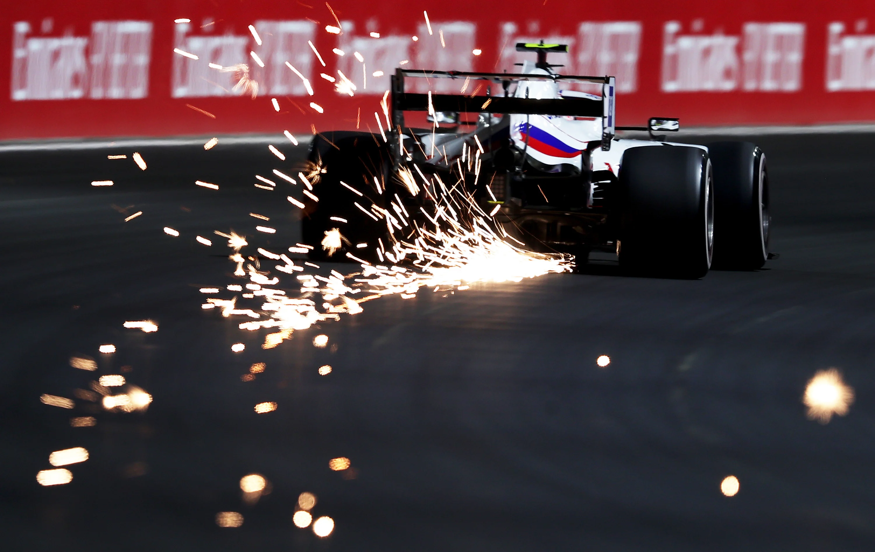 JEDDAH, SAUDI ARABIA - DECEMBER 03: Sparks fly behind Mick Schumacher of Germany driving the (47) Haas F1 Team VF-21 Ferrari during practice ahead of the F1 Grand Prix of Saudi Arabia at Jeddah Corniche Circuit on December 03, 2021 in Jeddah, Saudi Arabia. (Photo by Lars Baron/Getty Images)