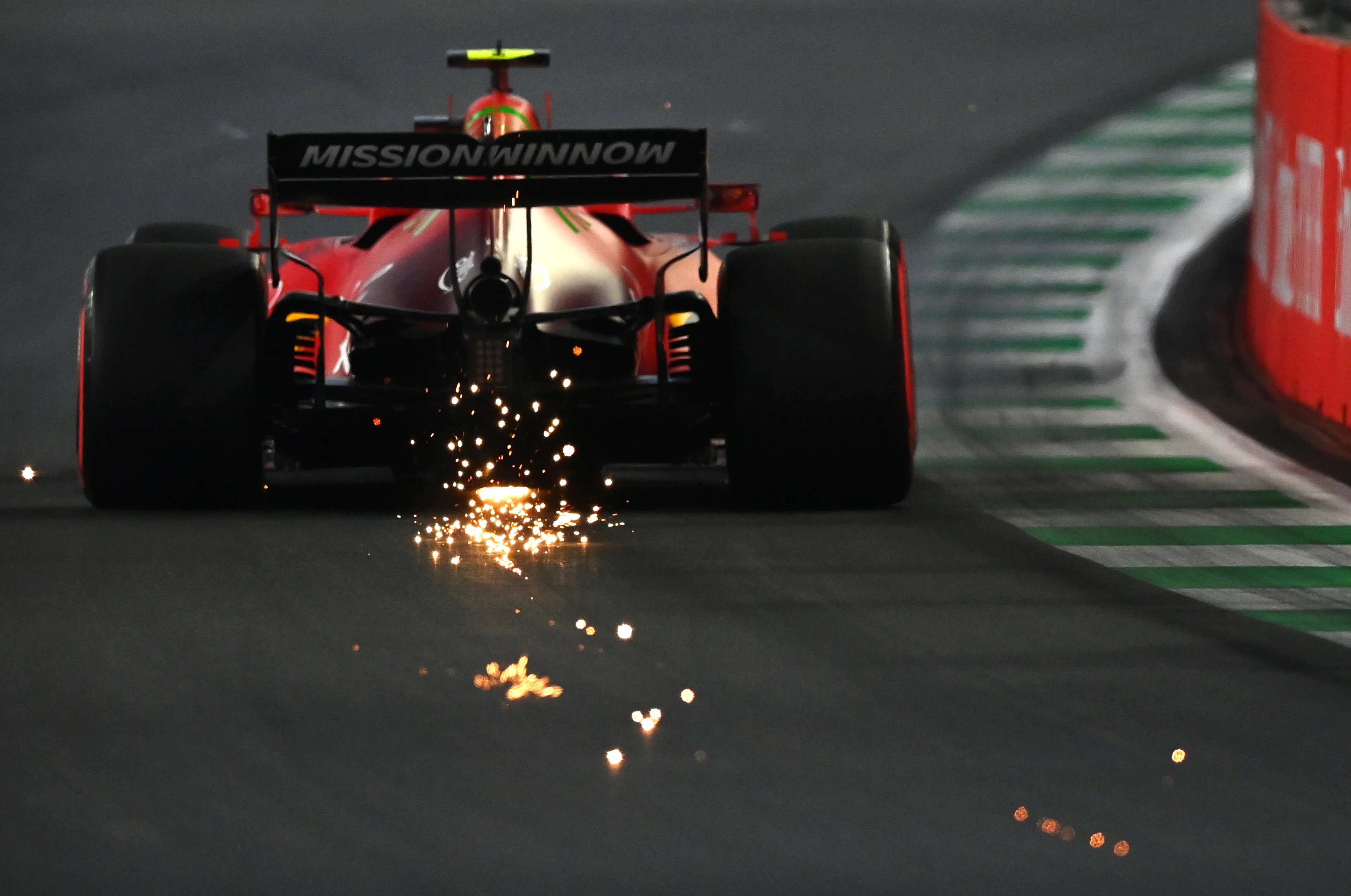 JEDDAH, SAUDI ARABIA - DECEMBER 04: Sparks fly behind Carlos Sainz of Spain driving the (55) Scuderia Ferrari SF21 during final practice ahead of the F1 Grand Prix of Saudi Arabia at Jeddah Corniche Circuit on December 04, 2021 in Jeddah, Saudi Arabia. (Photo by Dan Mullan/Getty Images)