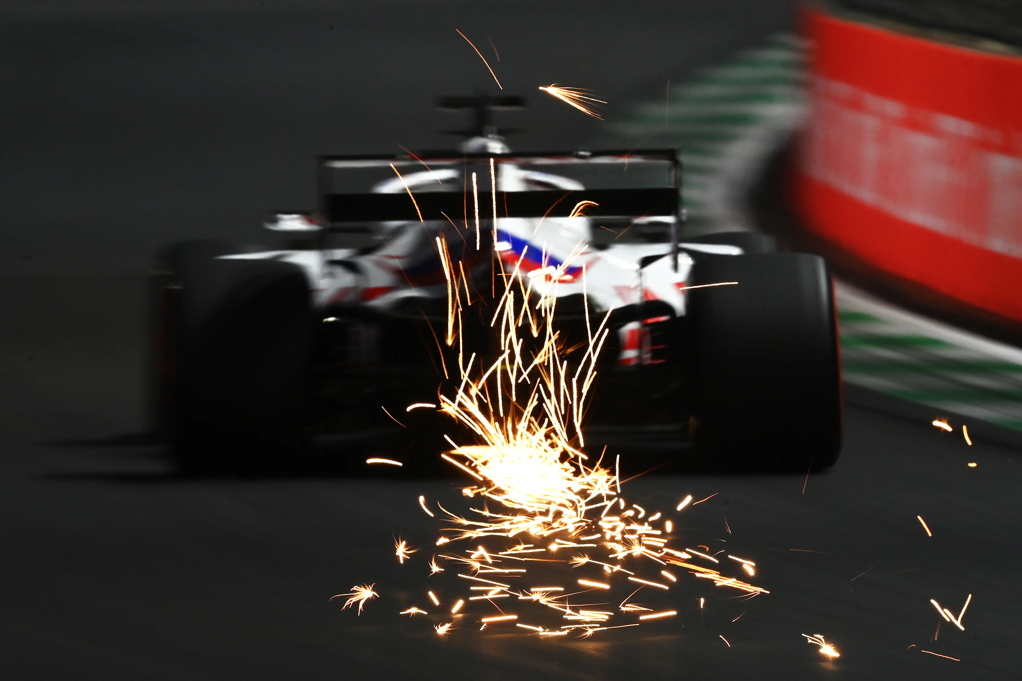 JEDDAH, SAUDI ARABIA - DECEMBER 04: Sparks fly behind Nikita Mazepin of Russia driving the (9) Haas F1 Team VF-21 Ferrari during final practice ahead of the F1 Grand Prix of Saudi Arabia at Jeddah Corniche Circuit on December 04, 2021 in Jeddah, Saudi Arabia. (Photo by Dan Mullan/Getty Images)