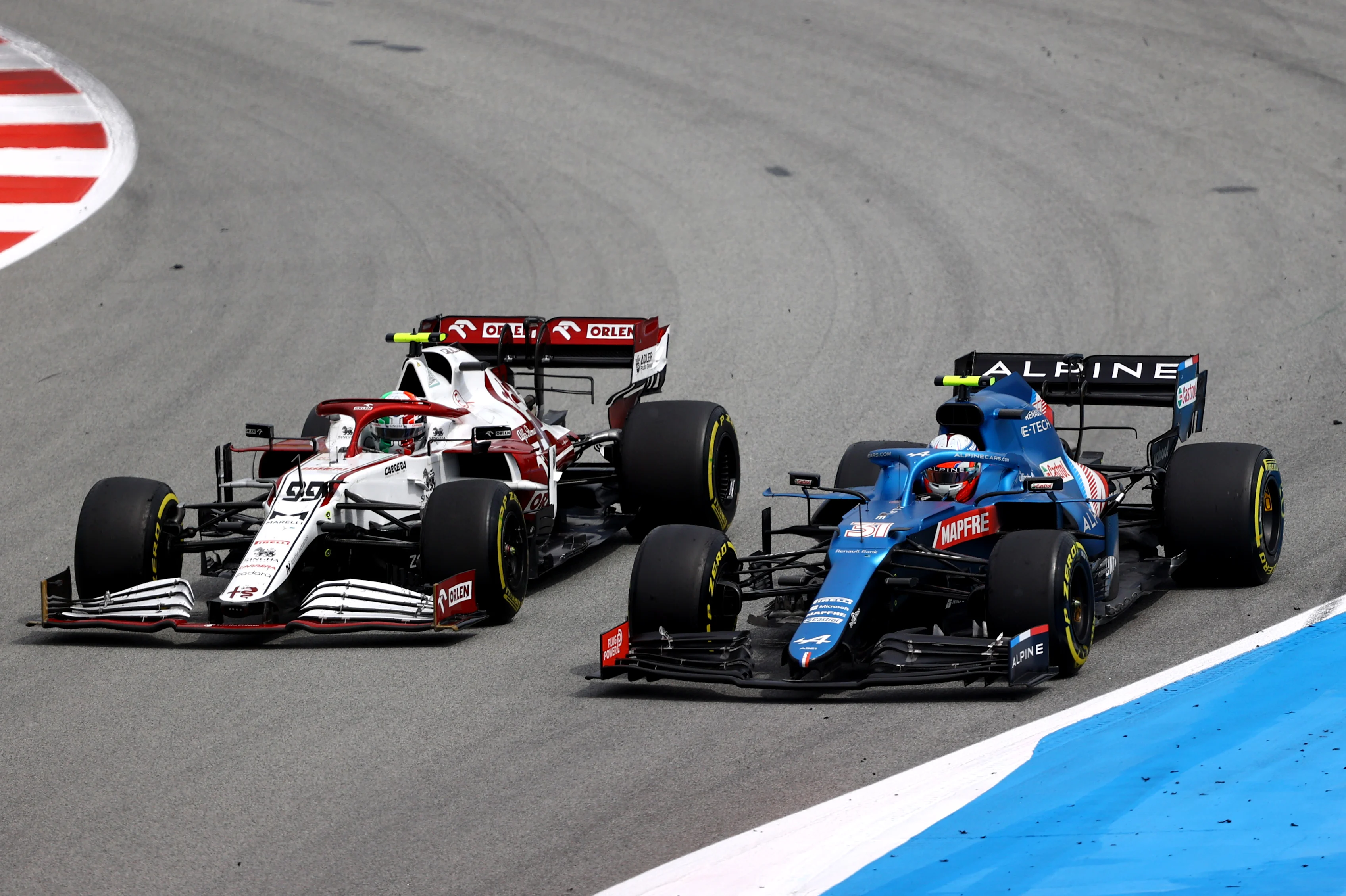 BARCELONA, SPAIN - MAY 09: Esteban Ocon of France driving the (31) Alpine A521 Renault and Antonio Giovinazzi of Italy driving the (99) Alfa Romeo Racing C41 Ferrari compete for position on track during the F1 Grand Prix of Spain at Circuit de Barcelona-Catalunya on May 09, 2021 in Barcelona, Spain. (Photo by Bryn Lennon/Getty Images)