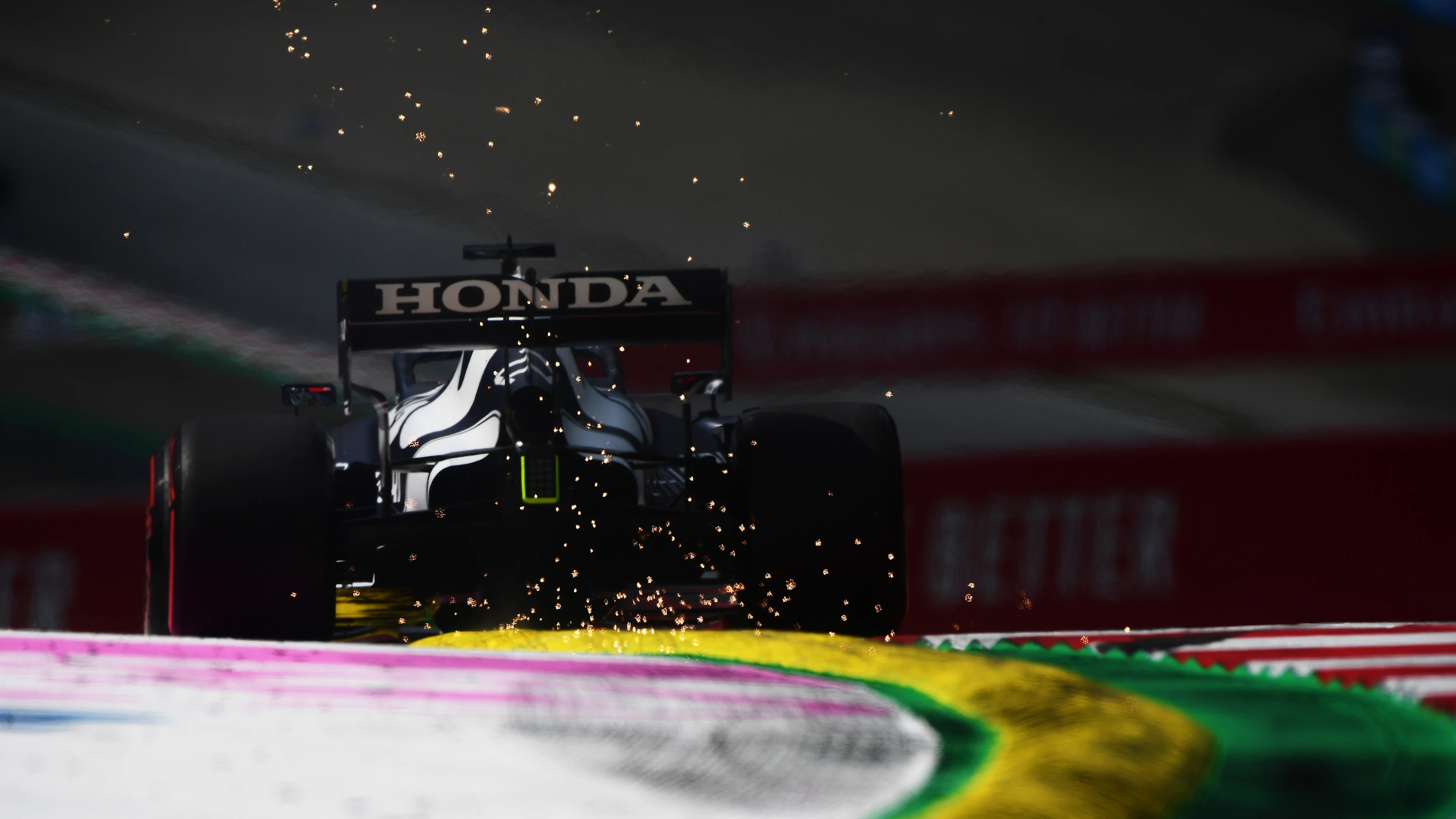SPIELBERG, AUSTRIA - JUNE 25: Sparks fly behind Yuki Tsunoda of Japan driving the (22) Scuderia AlphaTauri AT02 Honda on track during practice ahead of the F1 Grand Prix of Styria at Red Bull Ring on June 25, 2021 in Spielberg, Austria. (Photo by Mario Renzi - Formula 1/Formula 1 via Getty Images)