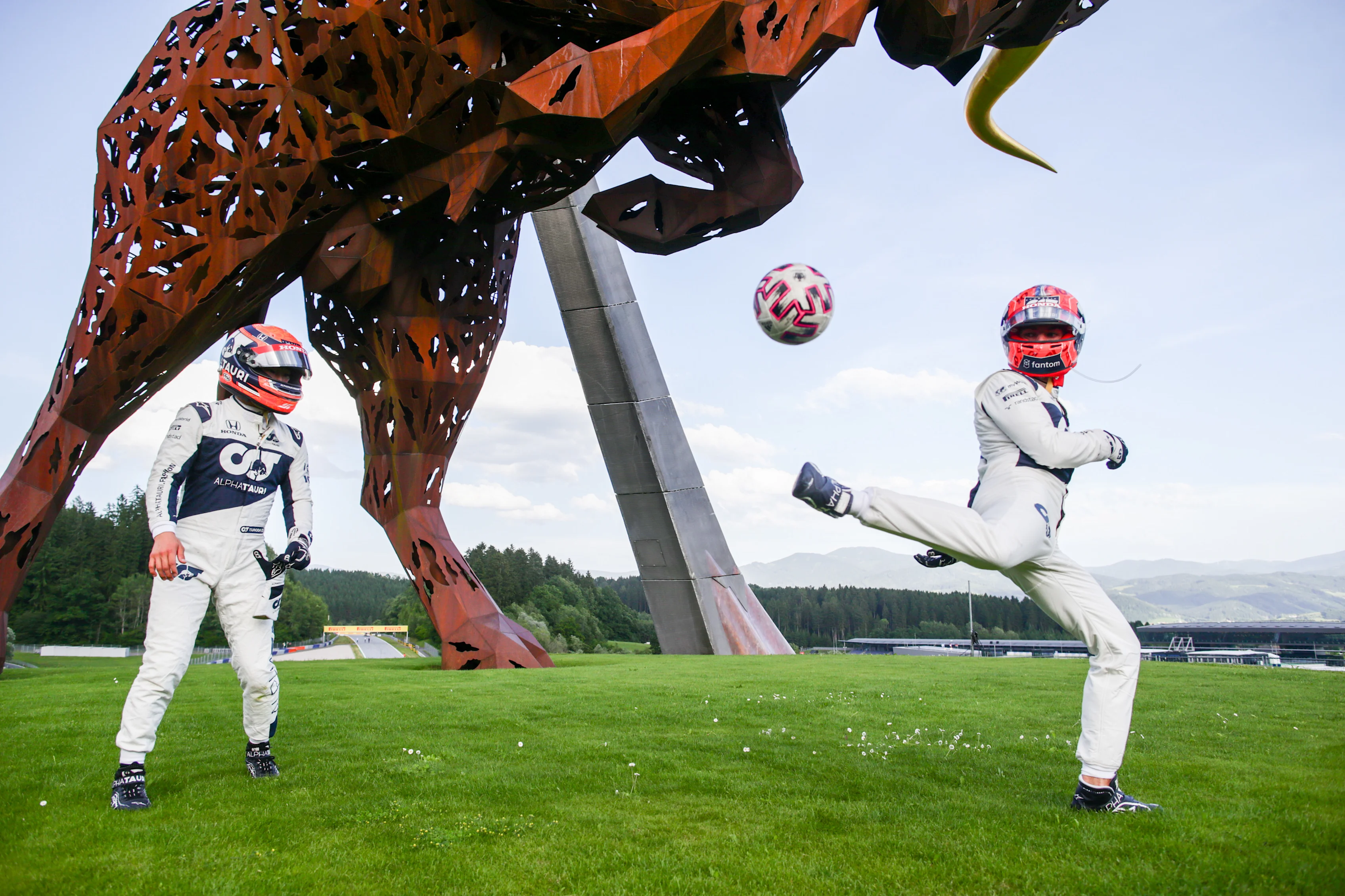 SPIELBERG, AUSTRIA - JUNE 24: Yuki Tsunoda of Scuderia AlphaTauri and Japan and Pierre Gasly of