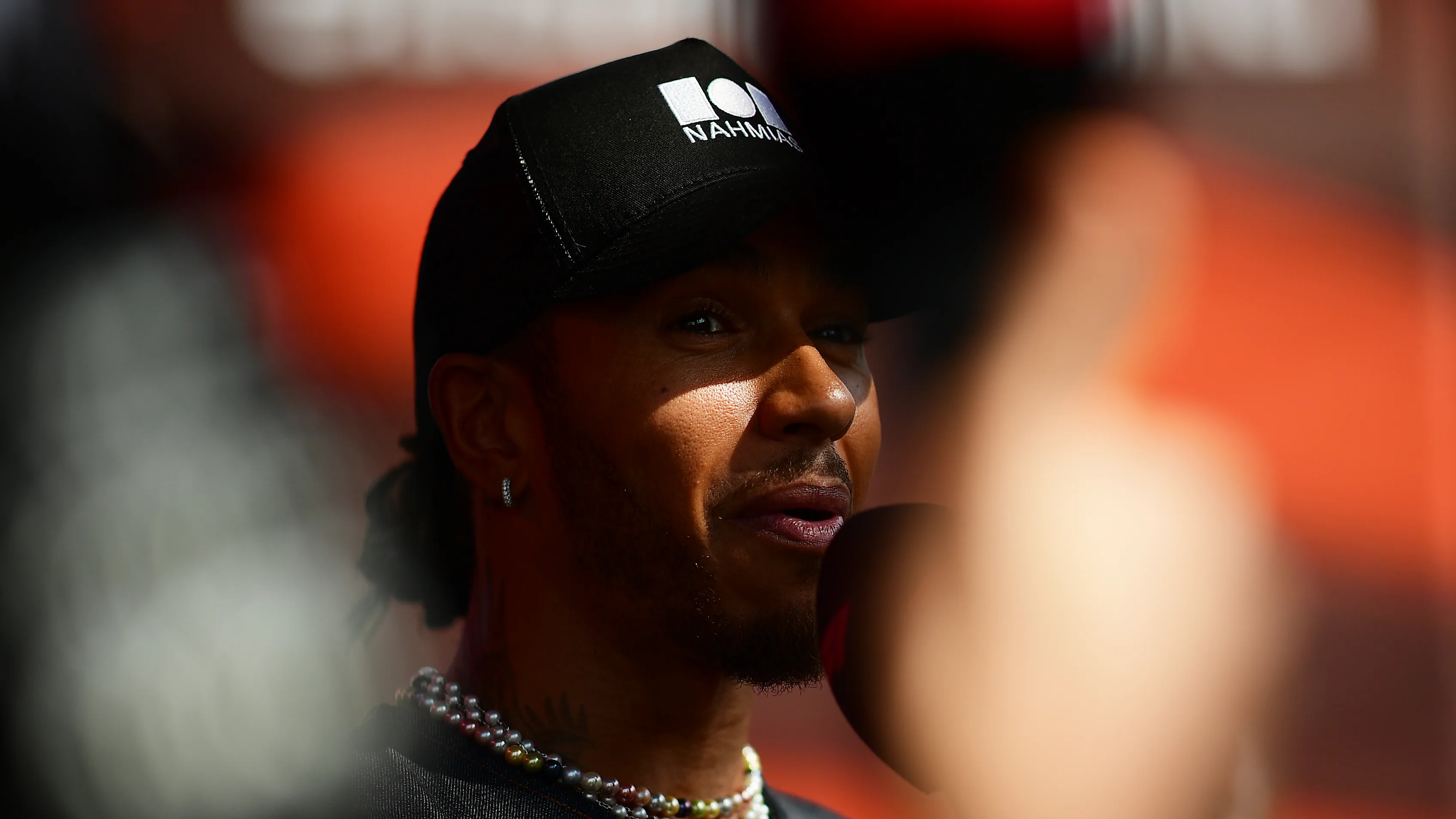 ABU DHABI, UNITED ARAB EMIRATES - NOVEMBER 19: Lewis Hamilton of Great Britain and Mercedes talks