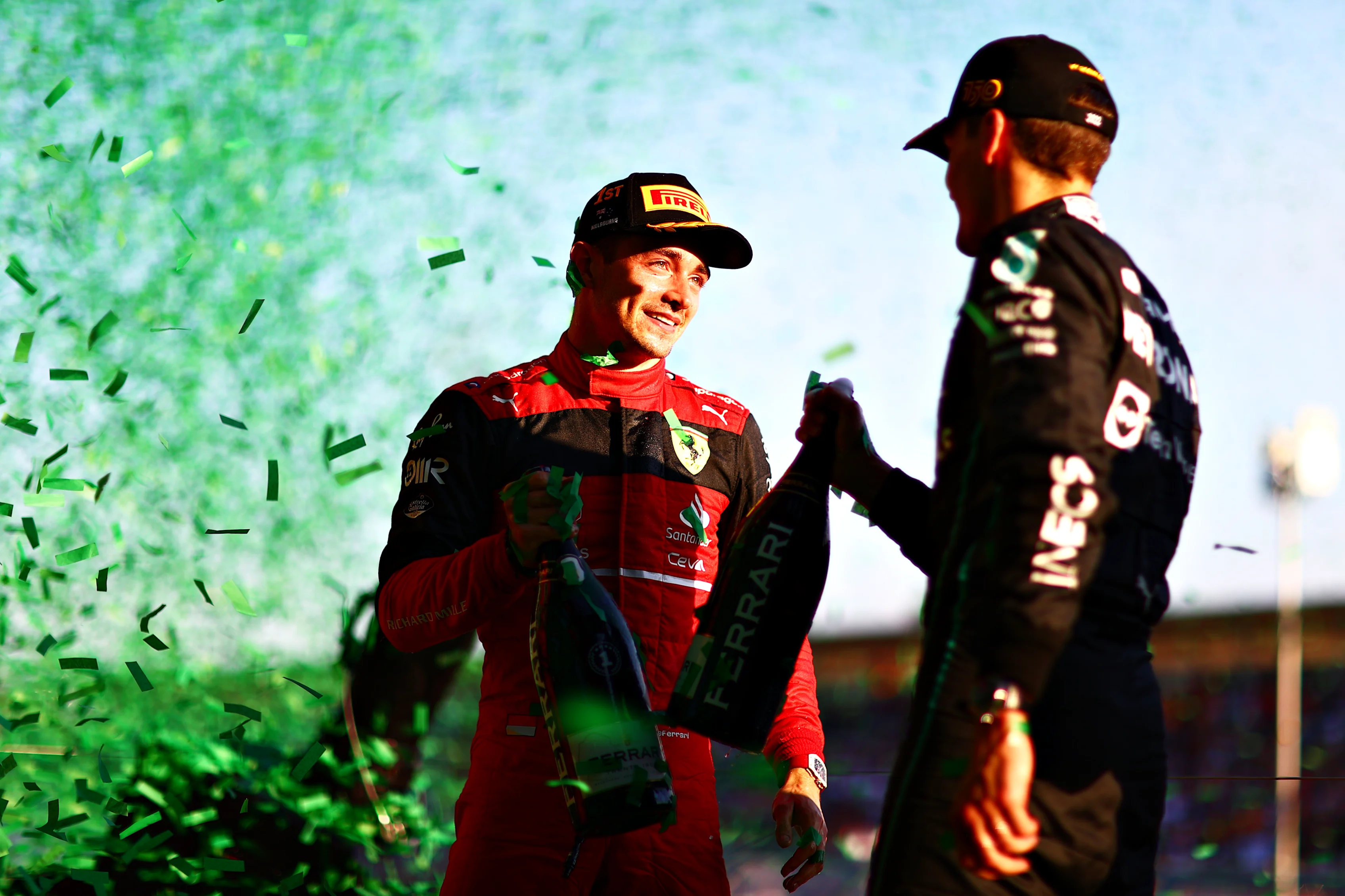 MELBOURNE, AUSTRALIA - APRIL 10: Race winner Charles Leclerc of Monaco and Ferrari and Third placed George Russell of Great Britain and Mercedes talk on the podium during the F1 Grand Prix of Australia at Melbourne Grand Prix Circuit on April 10, 2022 in Melbourne, Australia. (Photo by Dan Istitene - Formula 1/Formula 1 via Getty Images)